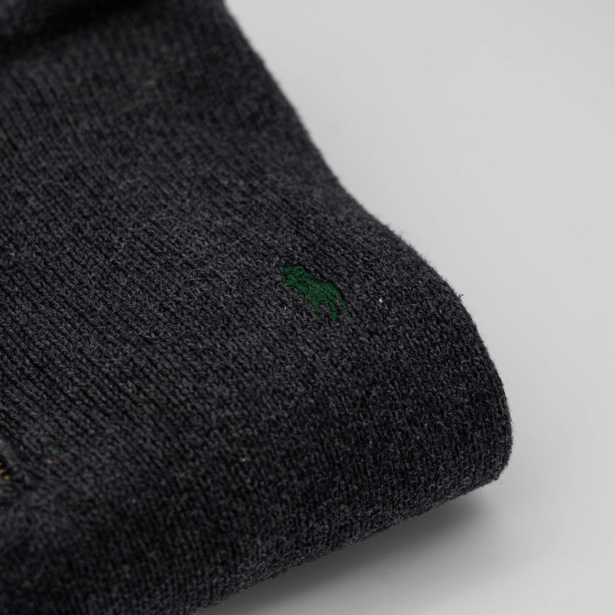 Dark grey Polo Ralph Lauren quarter zip mockneck pullover sweater with ribbed collar and green pony logo.
