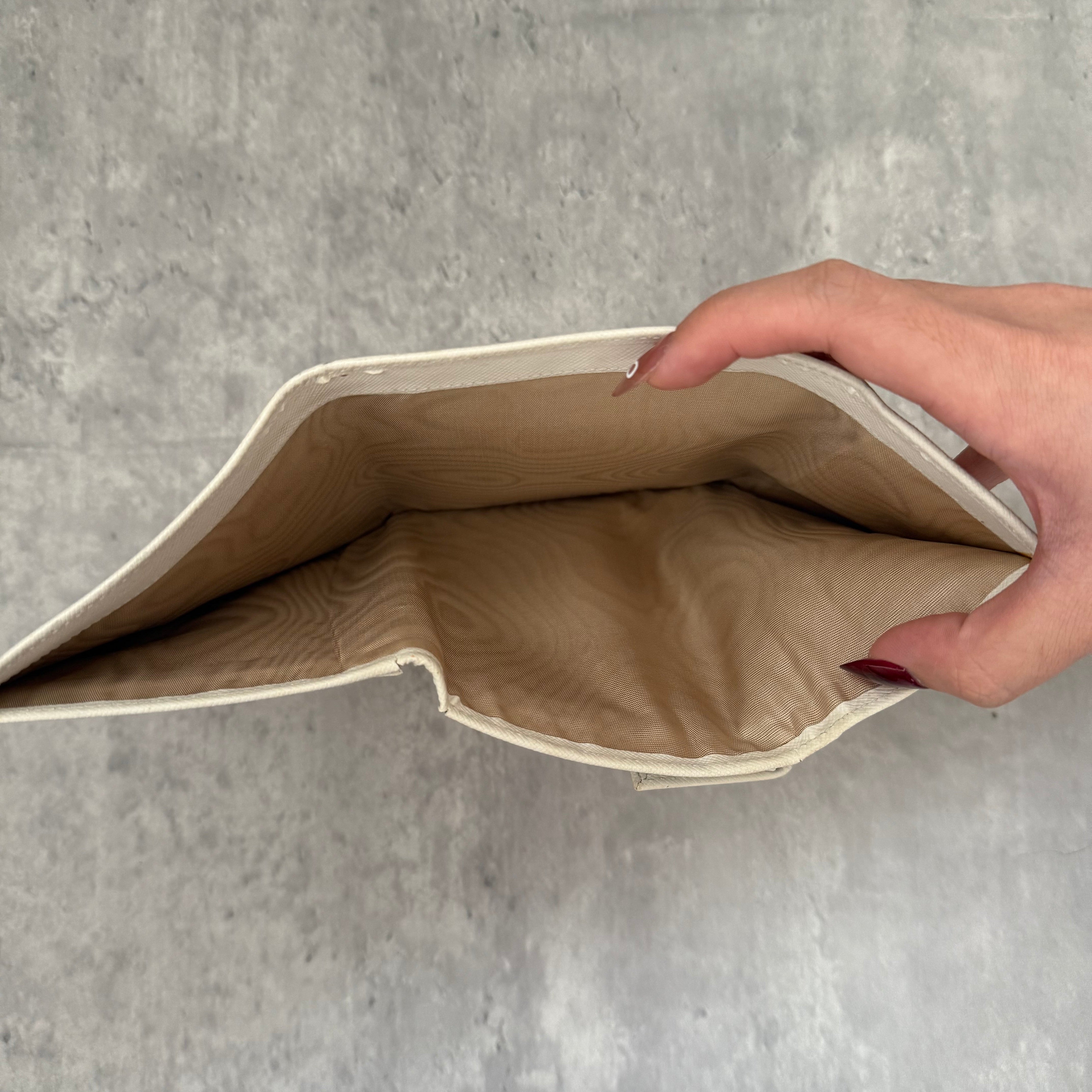 Pre-loved Prada Tessuto Nero leather trifold wallet with triangle logo plate in off-white, featuring card slots and a snap closure.