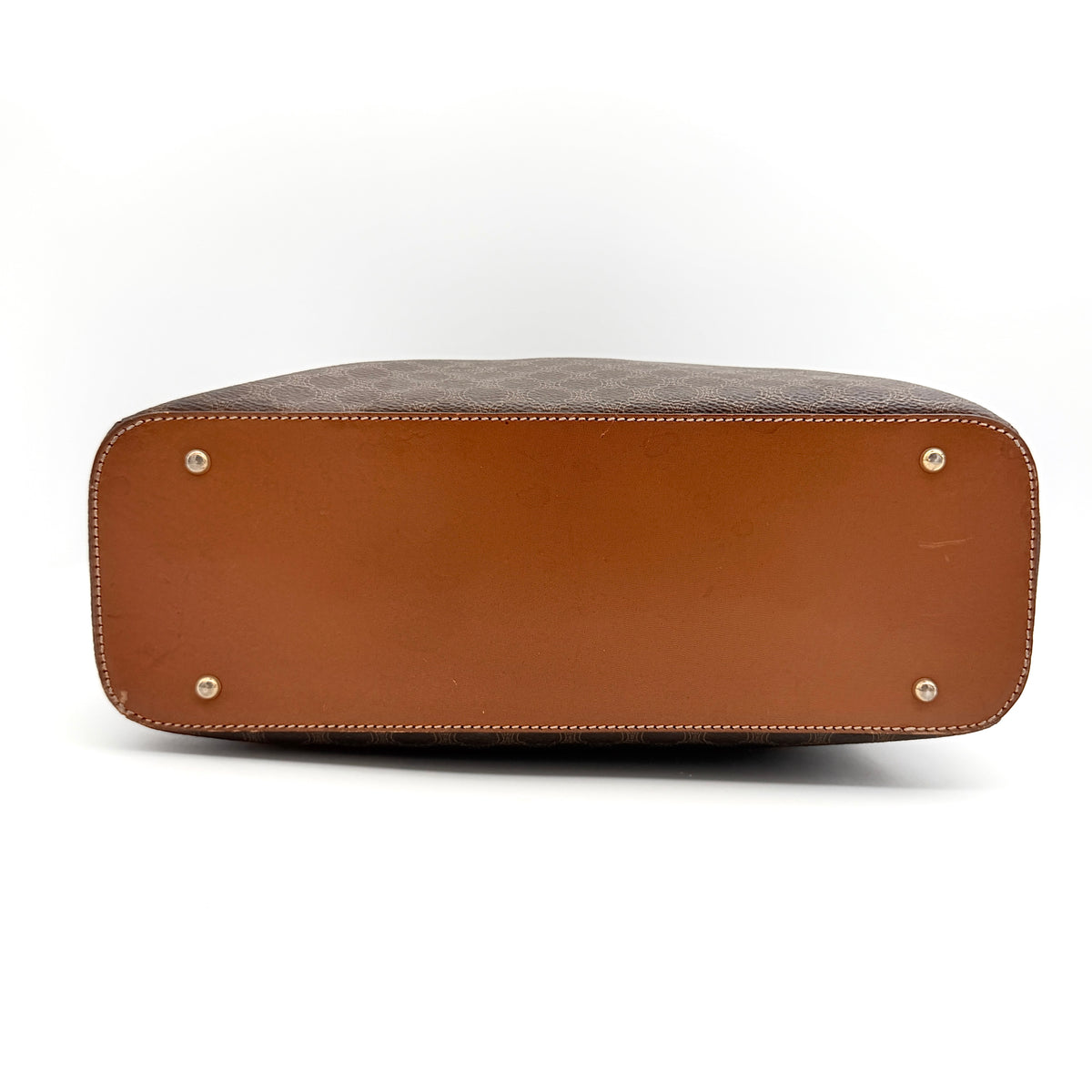 Front view of the Celine Triomphe Macadam Dome Handbag in brown, featuring the signature monogram canvas and tan leather details.