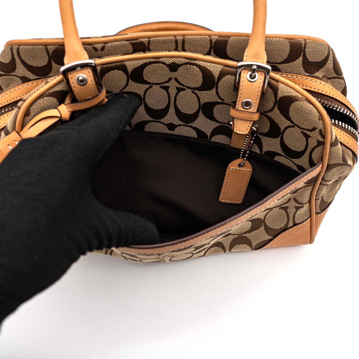 Coach Signature Hampton Satchel Boston Bag in beige and tan canvas with leather trim and silver hardware, styled on a clean background.