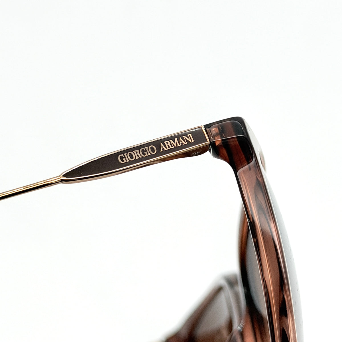 Giorgio Armani AR 8080-F sunglasses in brown tortoise with gradient brown lenses and slim gold-tone arms, displayed at an angle.