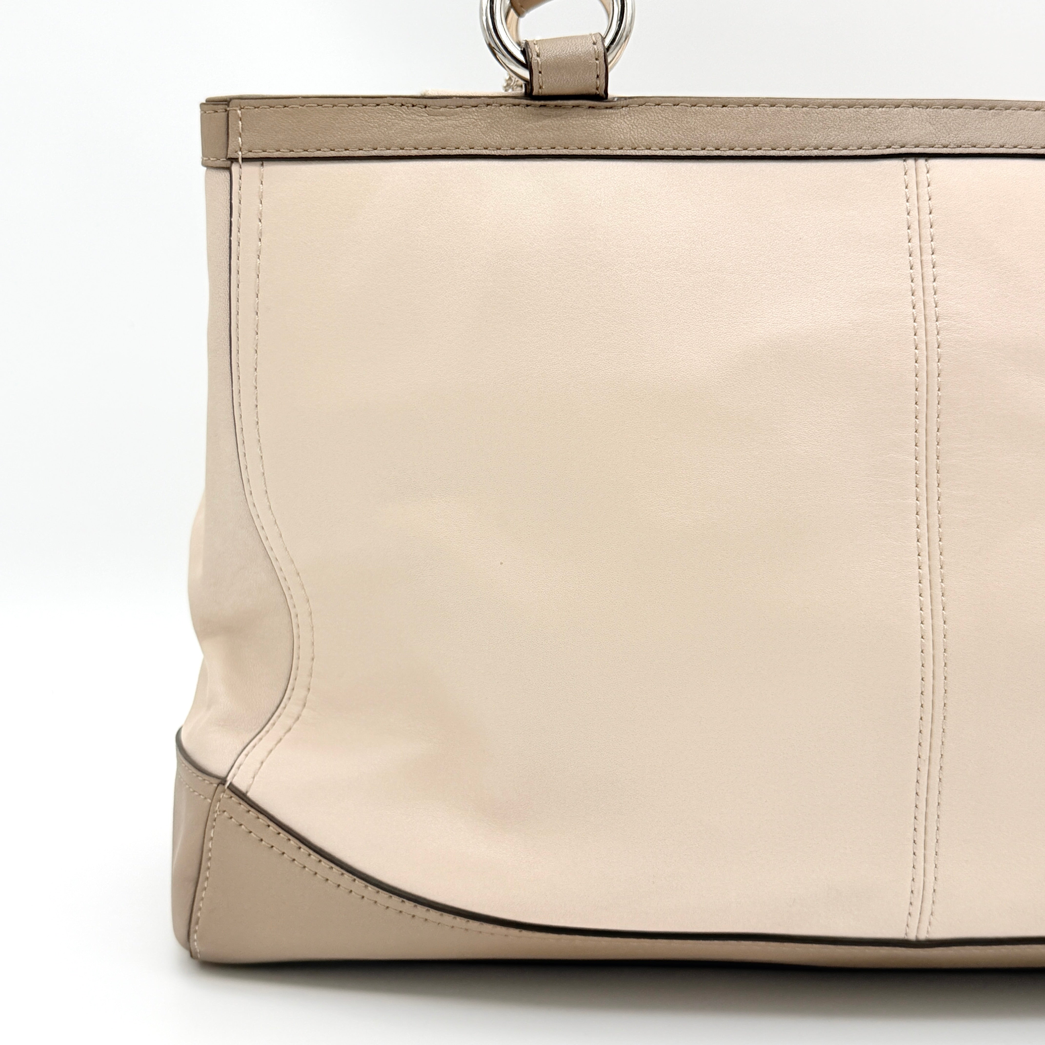Coach Park Carryall shoulder bag in cream and grey leather with dual handles and silver hardware, photographed on a white background.