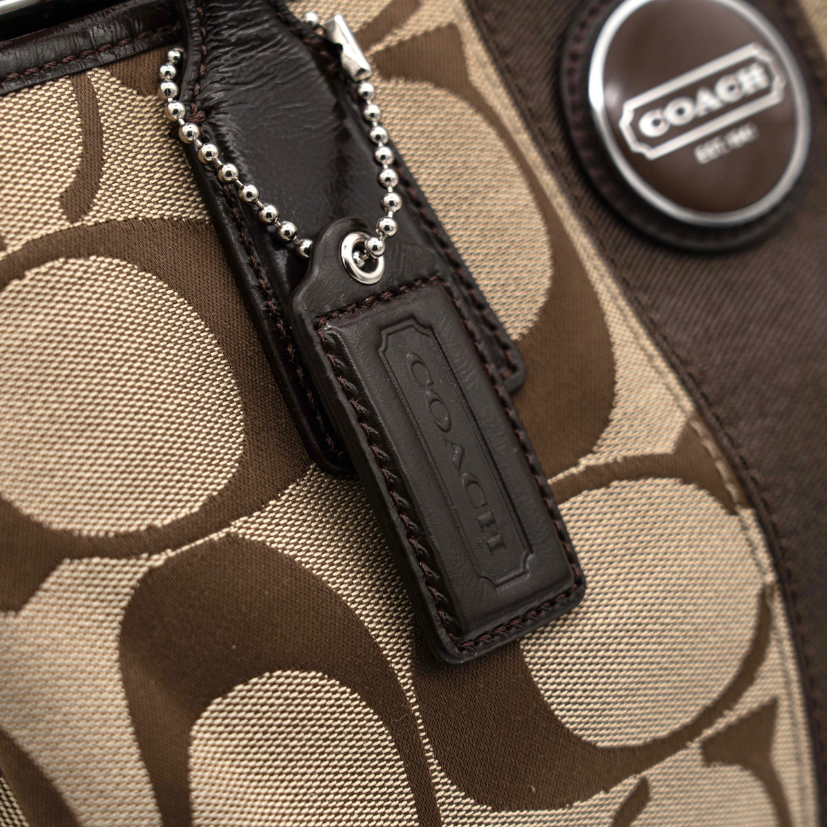 Coach Signature Stripe Frame Kisslock Shoulder Bag in beige and brown canvas with leather trim and signature monogram pattern.