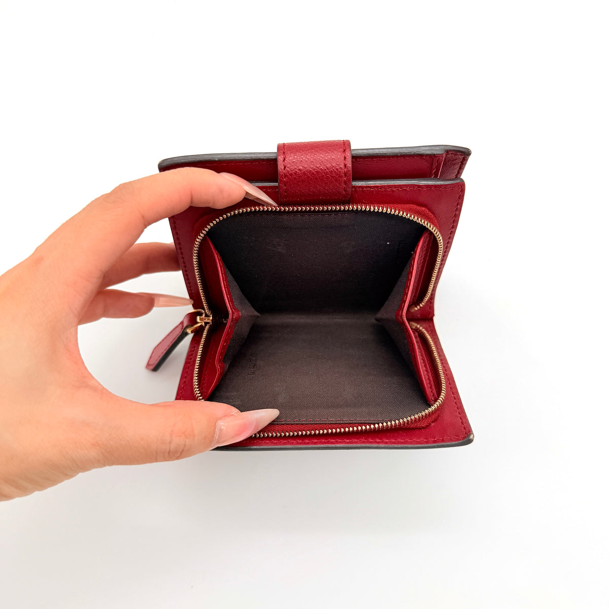 Fendi FF Embossed Logo Bifold Wallet in brown with red strap and gold Fendi hardware, displayed front on white background