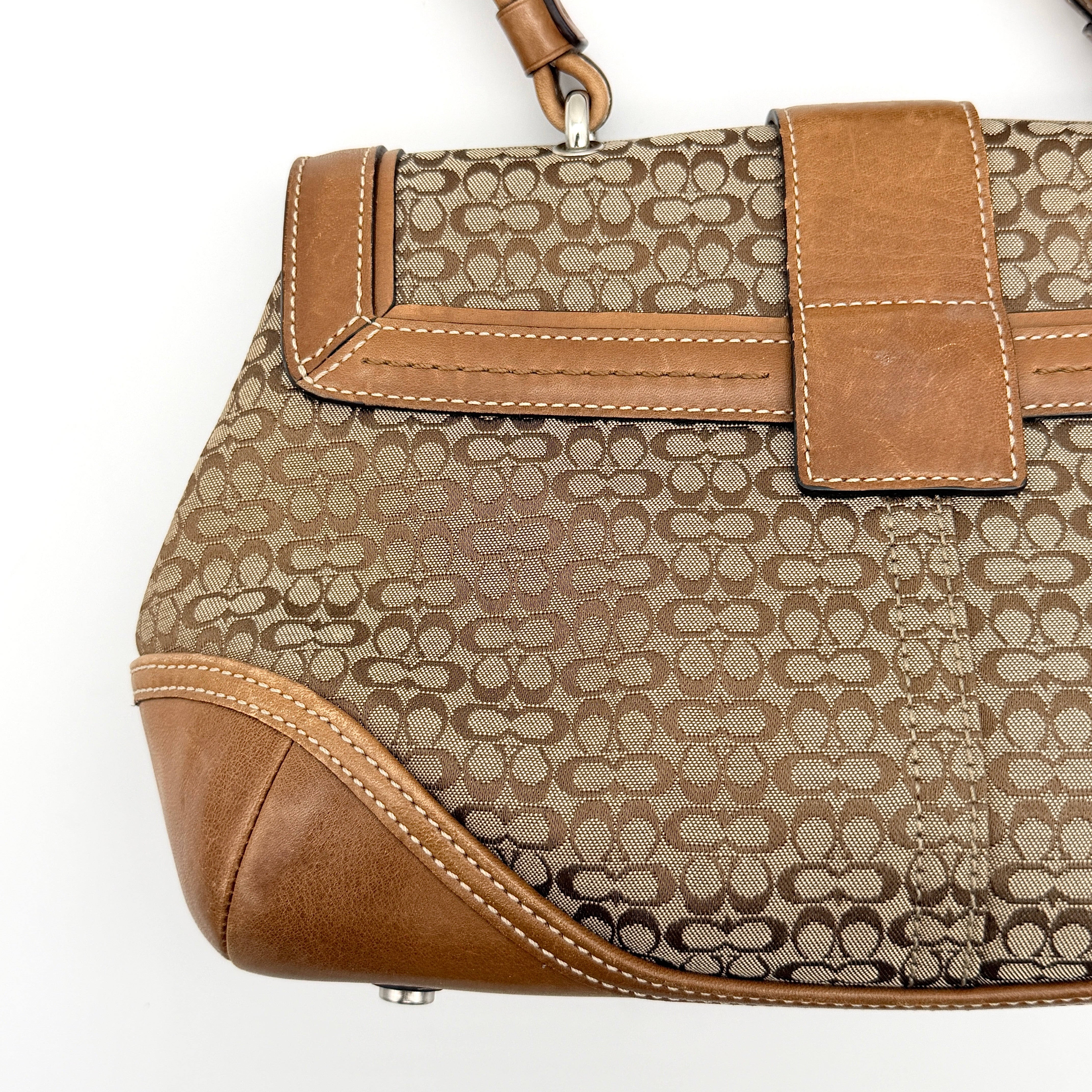 Coach Signature Soho Shoulder Bag in beige and tan monogram canvas with tan leather trim, shown on white background.