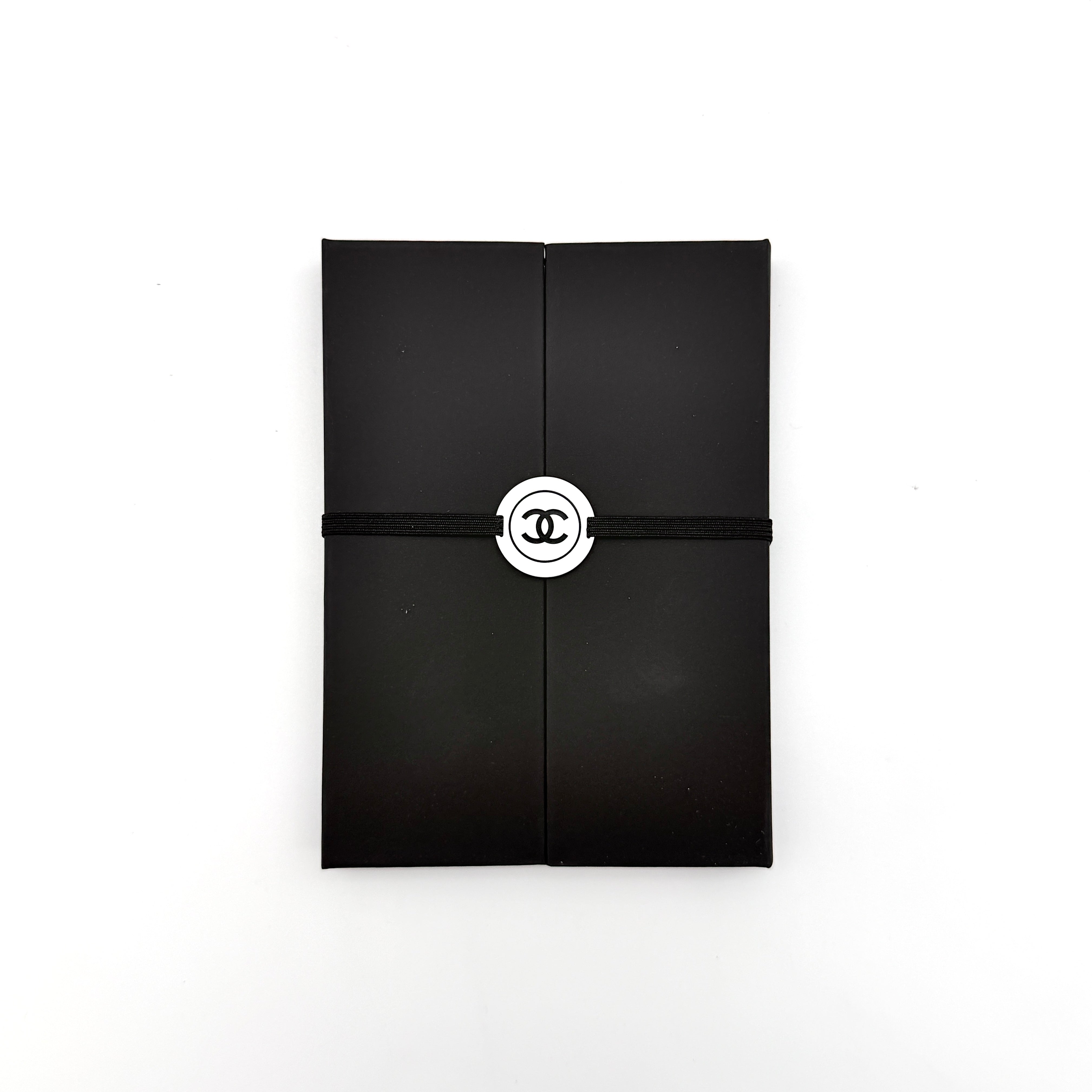 Chanel La Collection Novelty Book Stationary Set with black folder and branded box displayed on a white background