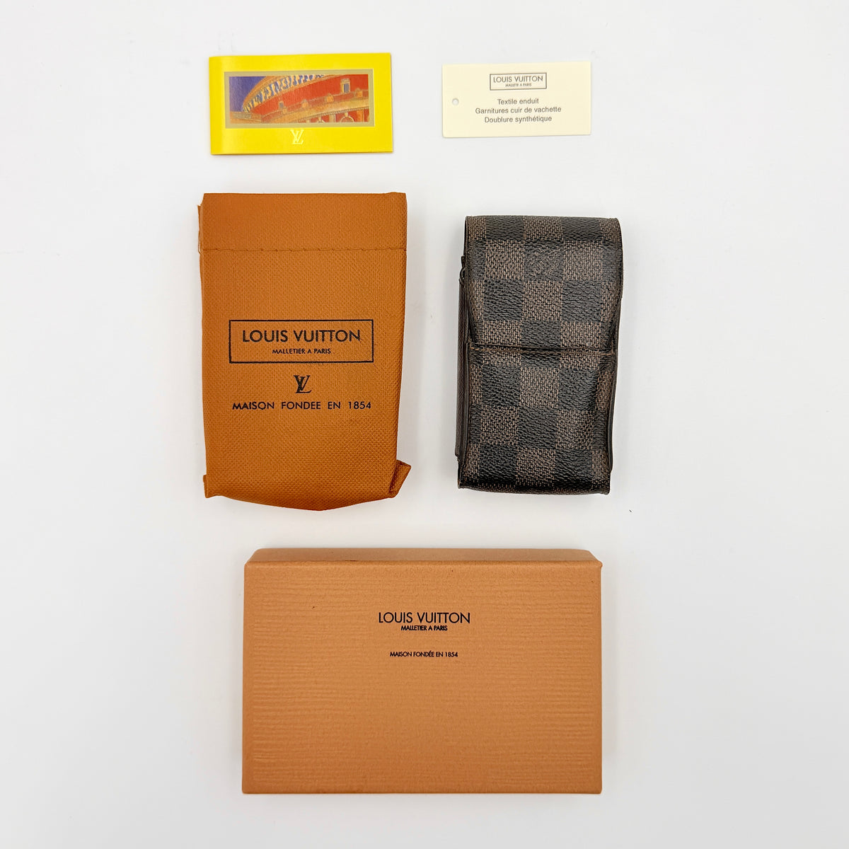 Louis Vuitton Damier Ebene Cigarette Case in brown coated canvas with original box, dust bag, and cards displayed.