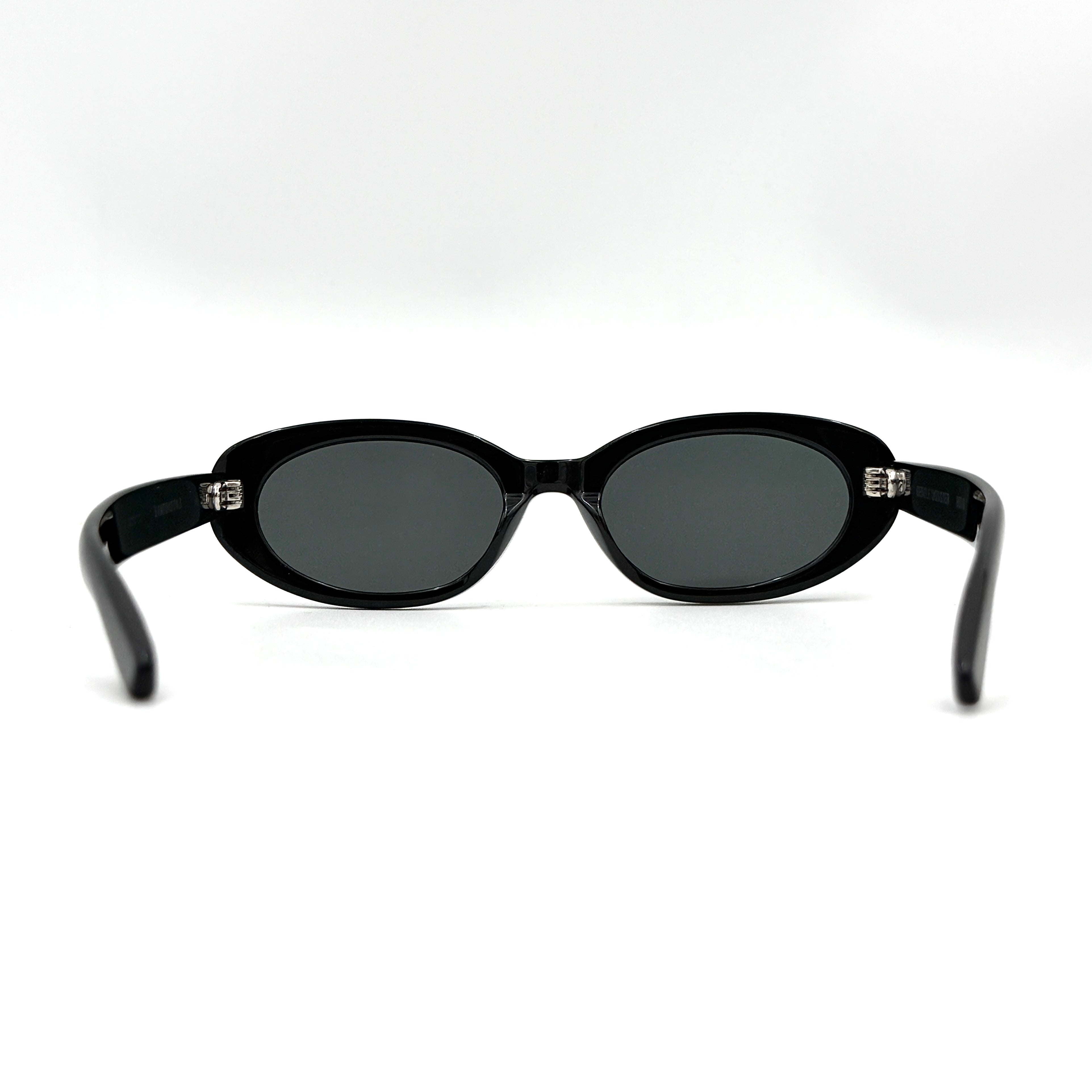 Gentle Monster Bandoneon.S sunglasses in black acetate with dark oval lenses and silver star accents shown from the side.