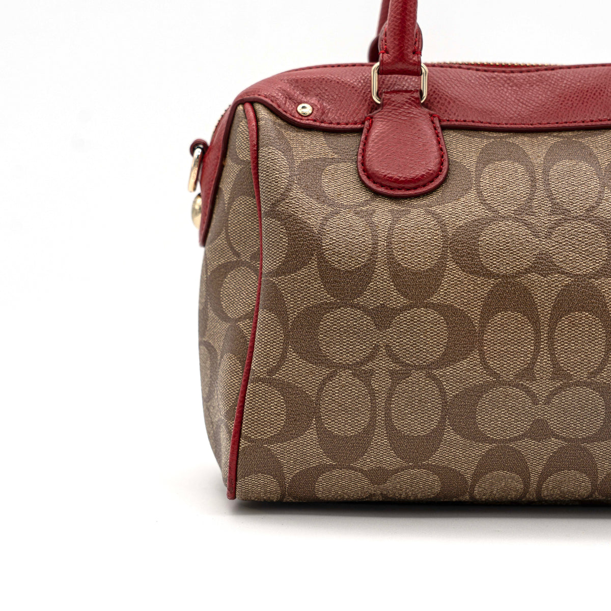 Coach Mini Bennett Boston bag in signature beige canvas with red leather trim, shown with detachable crossbody strap.