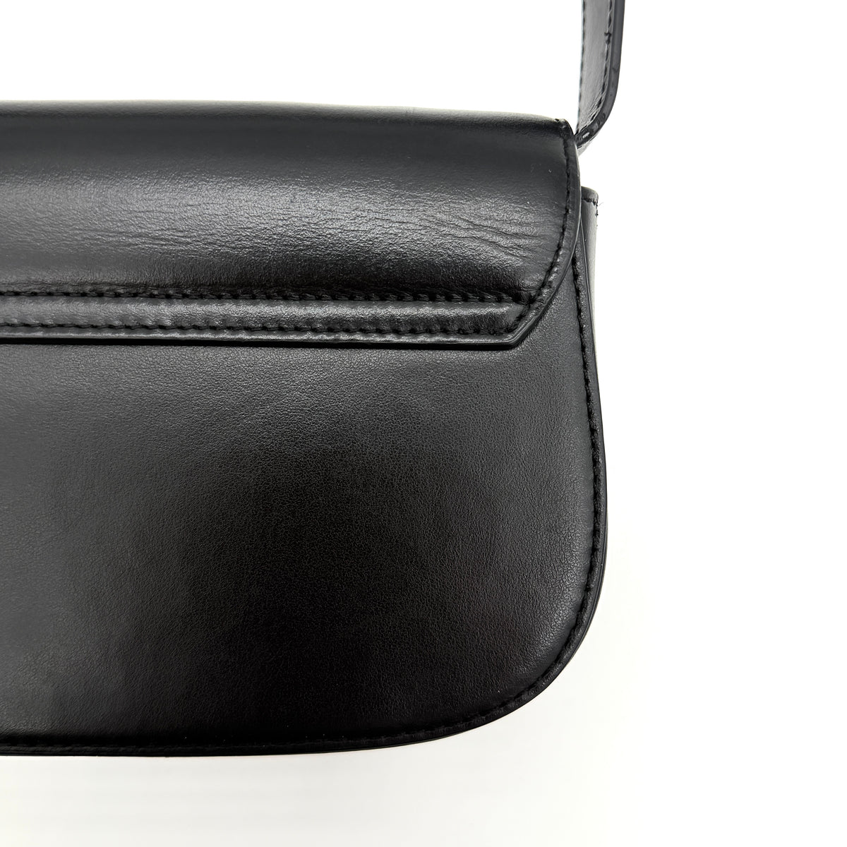 Diesel 1DR Shoulder Bag in black leather with a bold silver and black D logo plaque on the front flap.