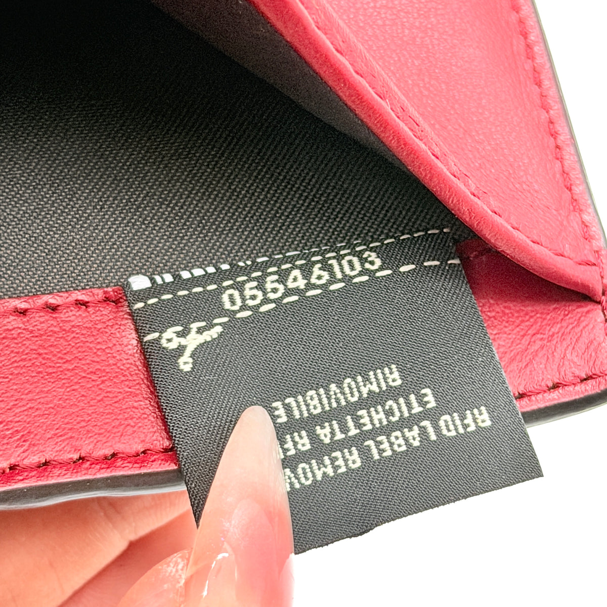 Fendi FF Embossed Logo Bifold Wallet in brown with red strap and gold Fendi hardware, displayed front on white background