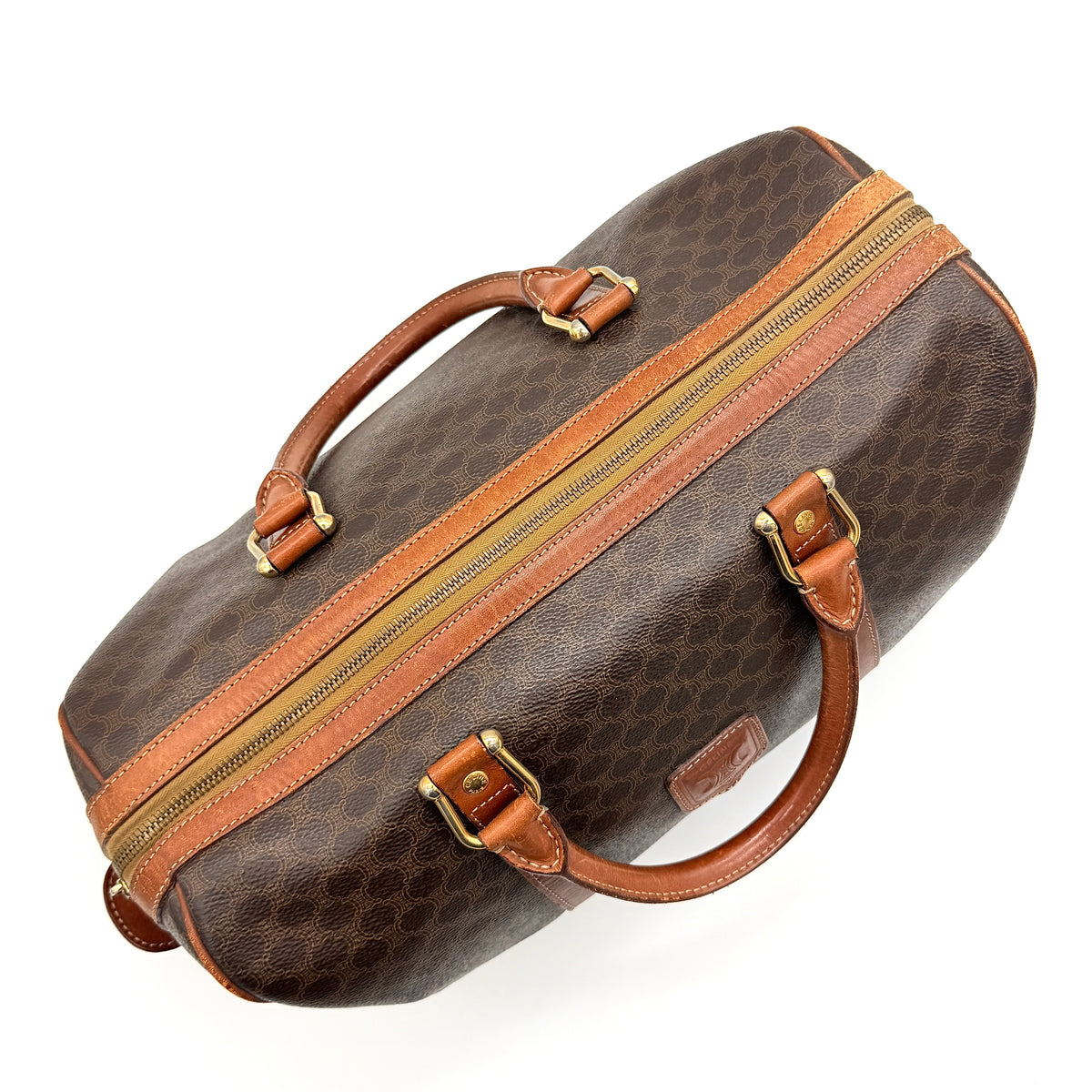 Celine Macadam Triomphe Boston Bag in brown coated canvas with tan leather and gold-tone hardware, shown against a white background.