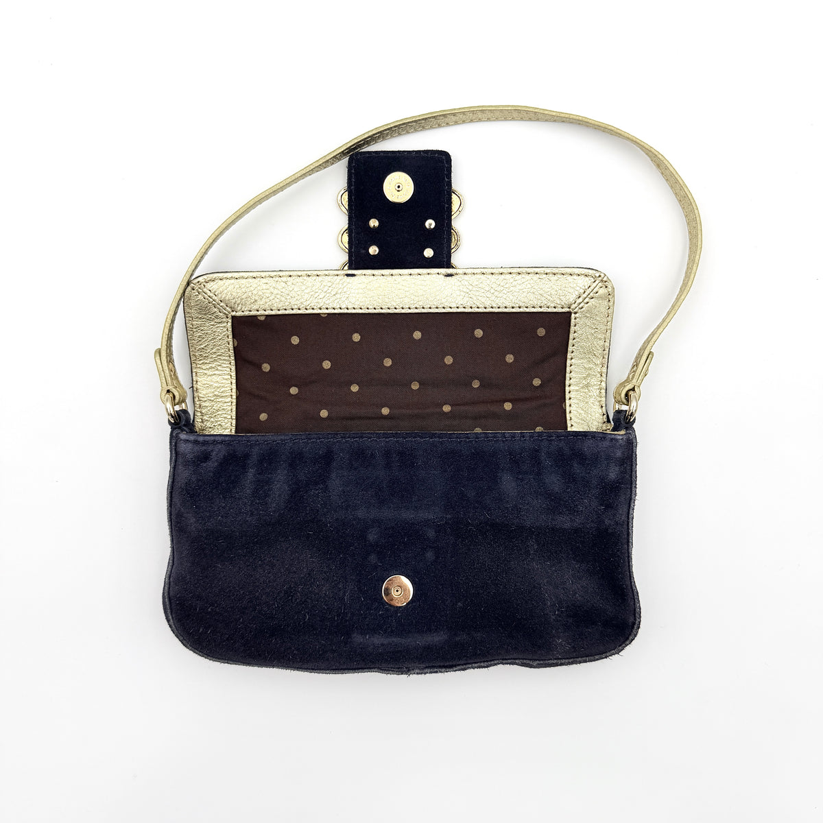 Navy blue suede Kate Spade baguette bag with floral gold hardware and gold-tone shoulder strap.