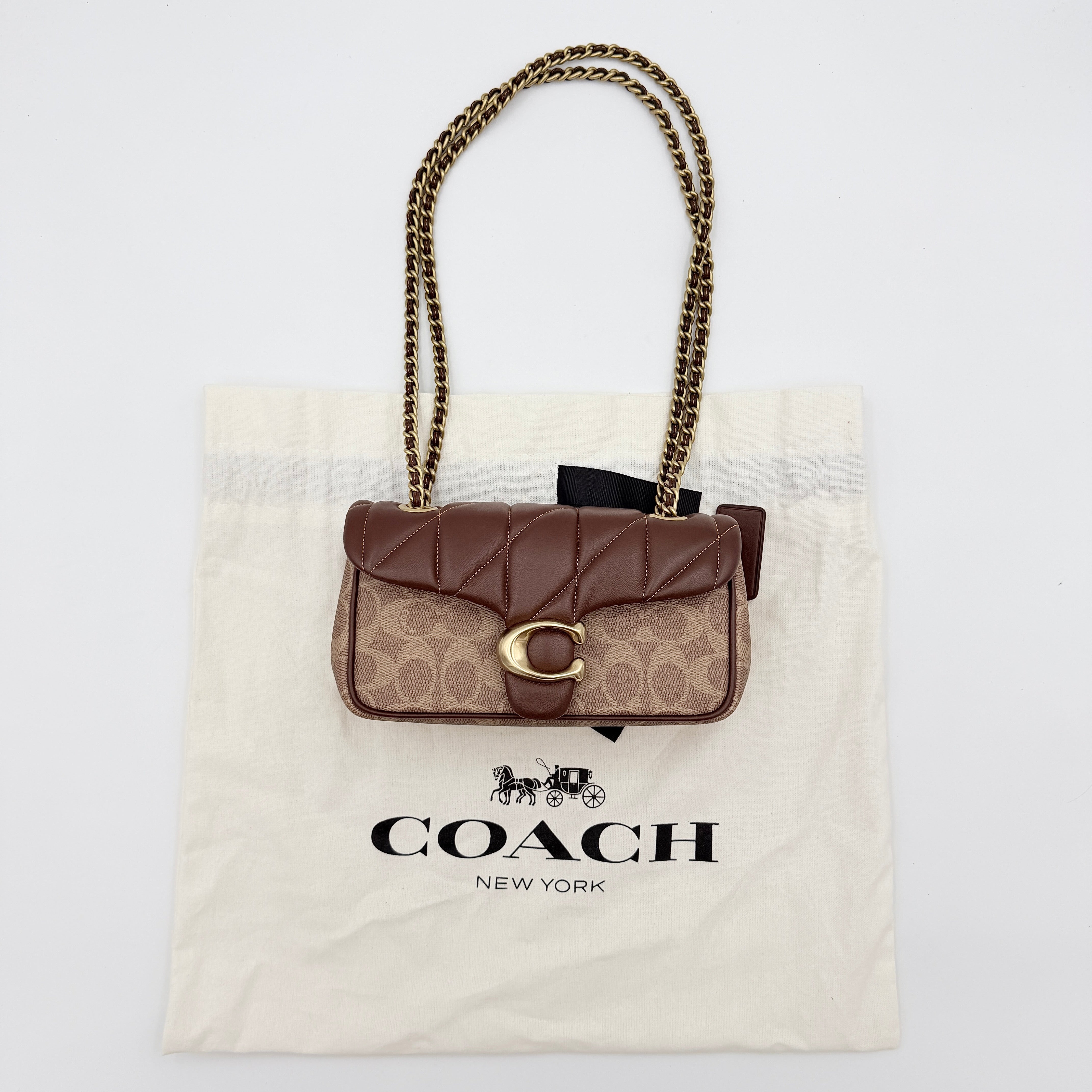 Coach Signature Quilted Tabby Shoulder Bag in brown monogram canvas with gold chain strap and oversized C clasp.