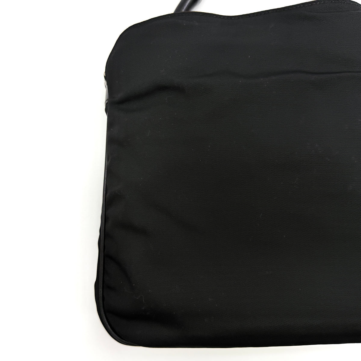 Gucci black nylon shoulder bag with bamboo handle and detachable strap shown with dust bag.