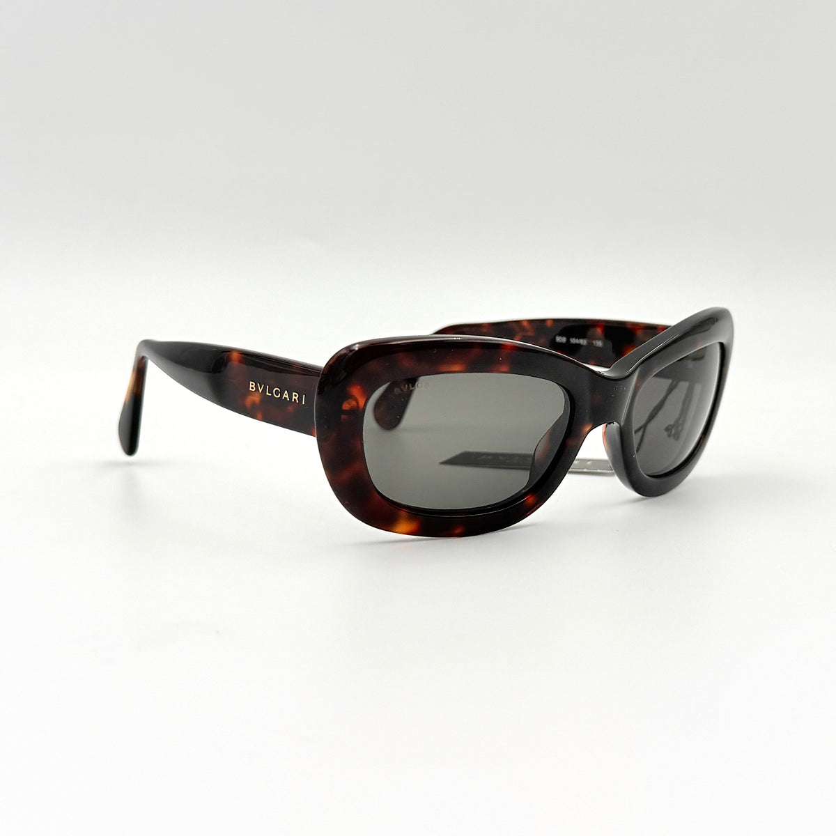 Bvlgari 808 sunglasses in tortoiseshell brown acetate displayed with original case and cloth.