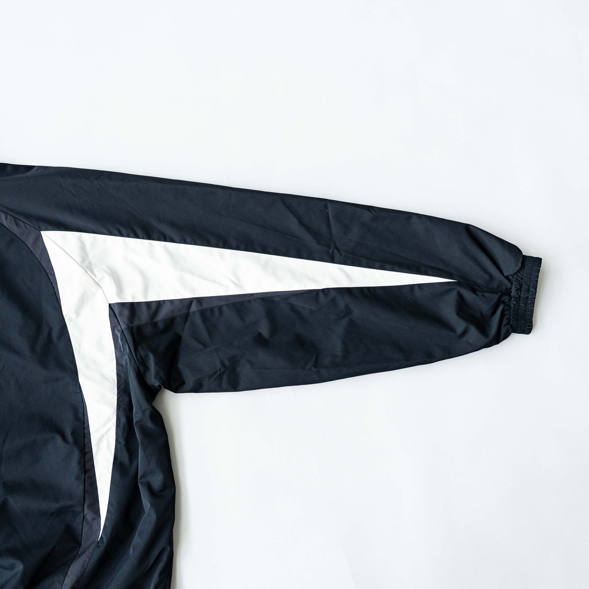 BAPE A Bathing Ape black and white logo track jacket with bold panel detailing, shown laid flat.