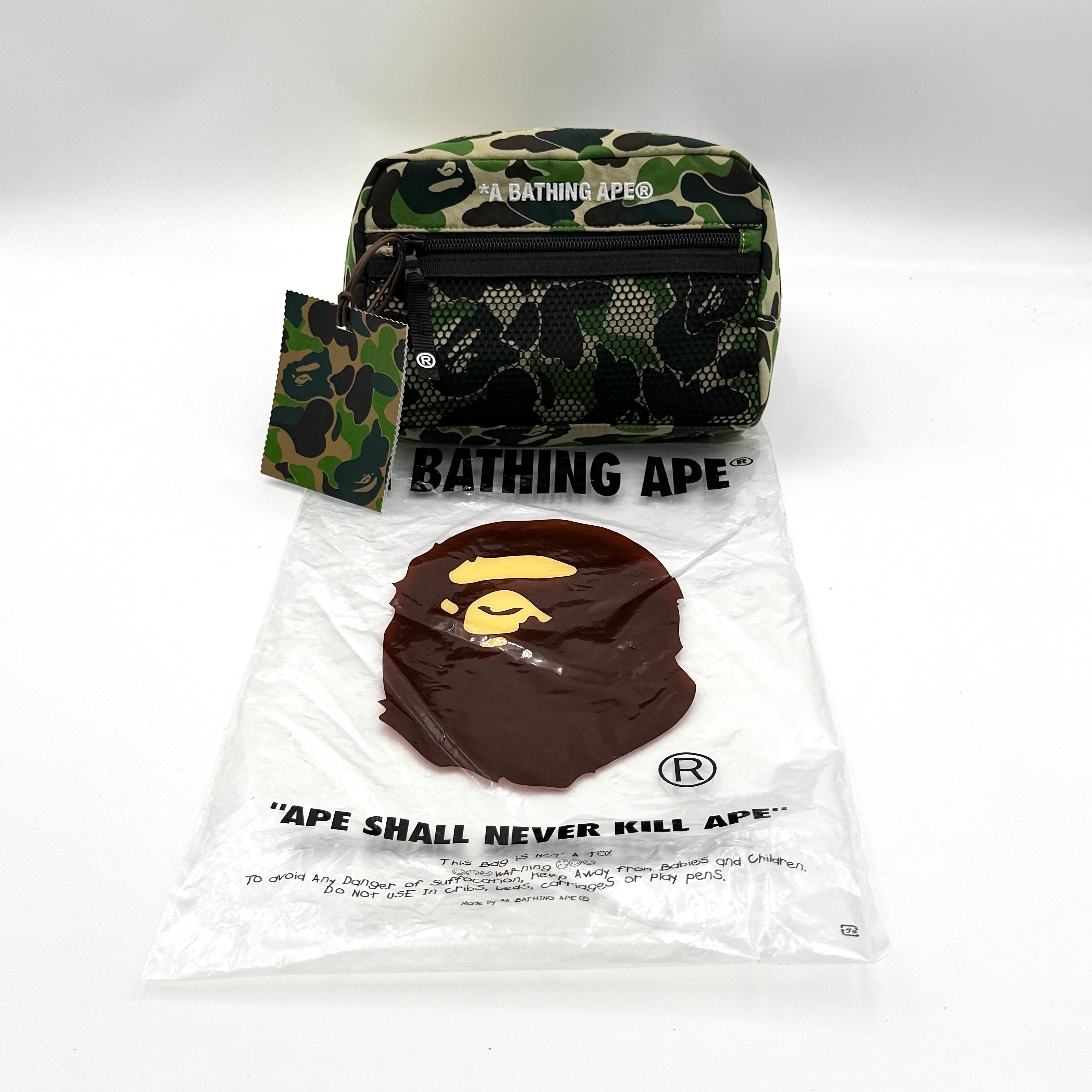 BAPE ABC Camo Pouch in green camouflage with mesh front pocket and embroidered A Bathing Ape logo.