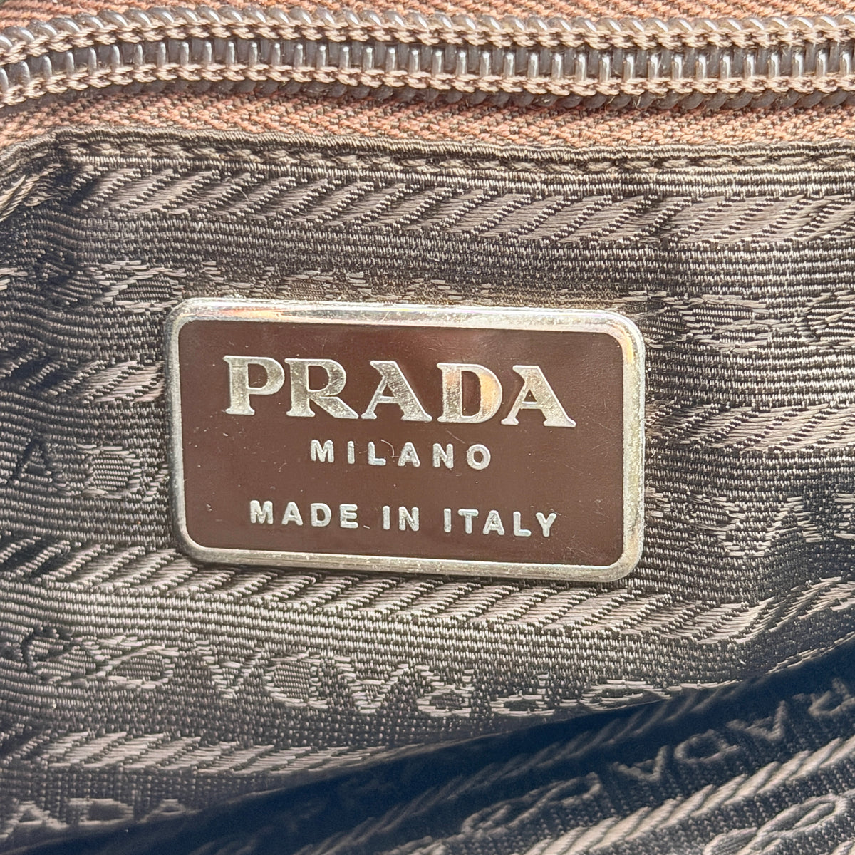 Prada Tessuto Nylon City Tote Bag in dark green nylon with double handles and signature triangle logo plaque on the front.