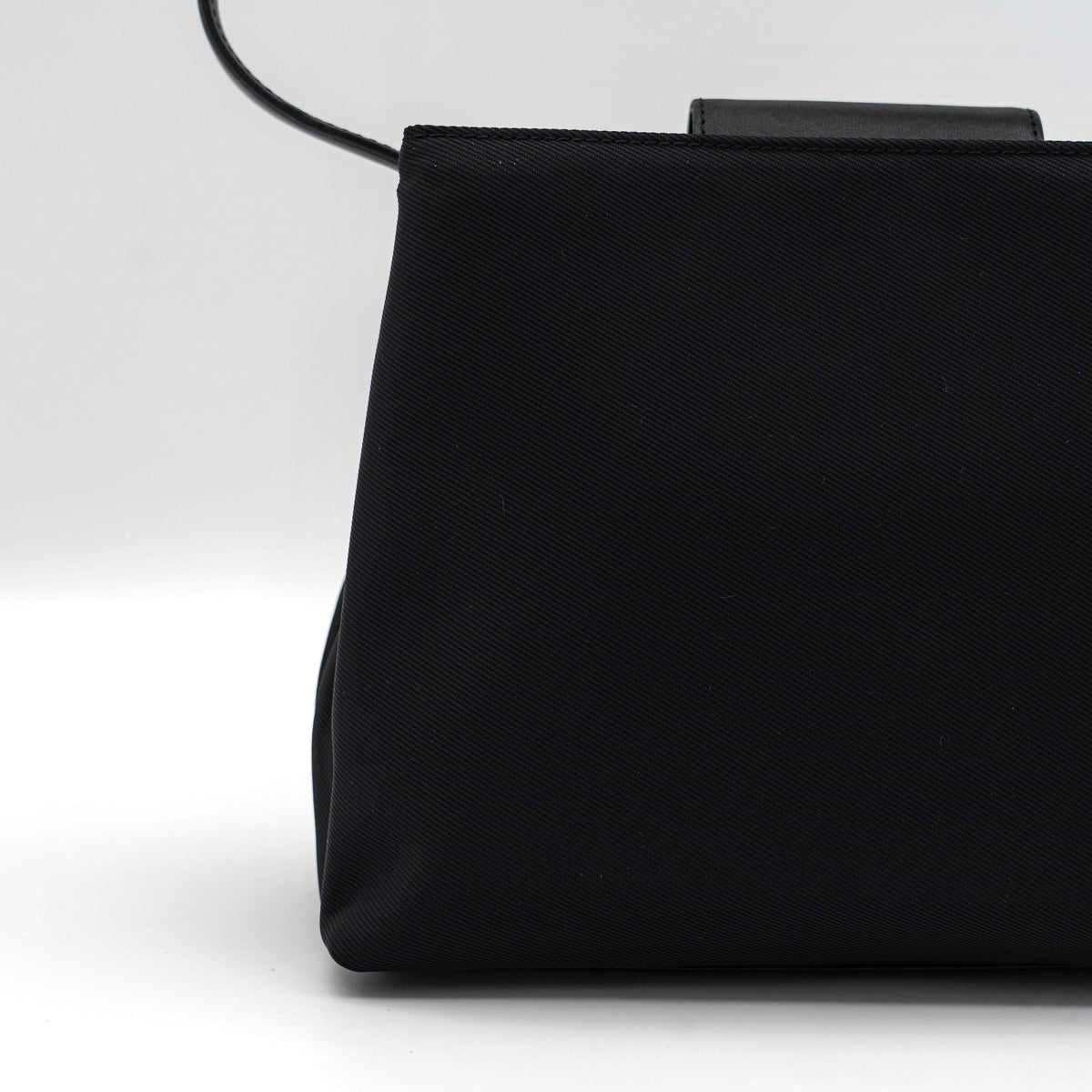 Coach Mercer tote bag in black nylon with leather handle and trim, presented against a white background.