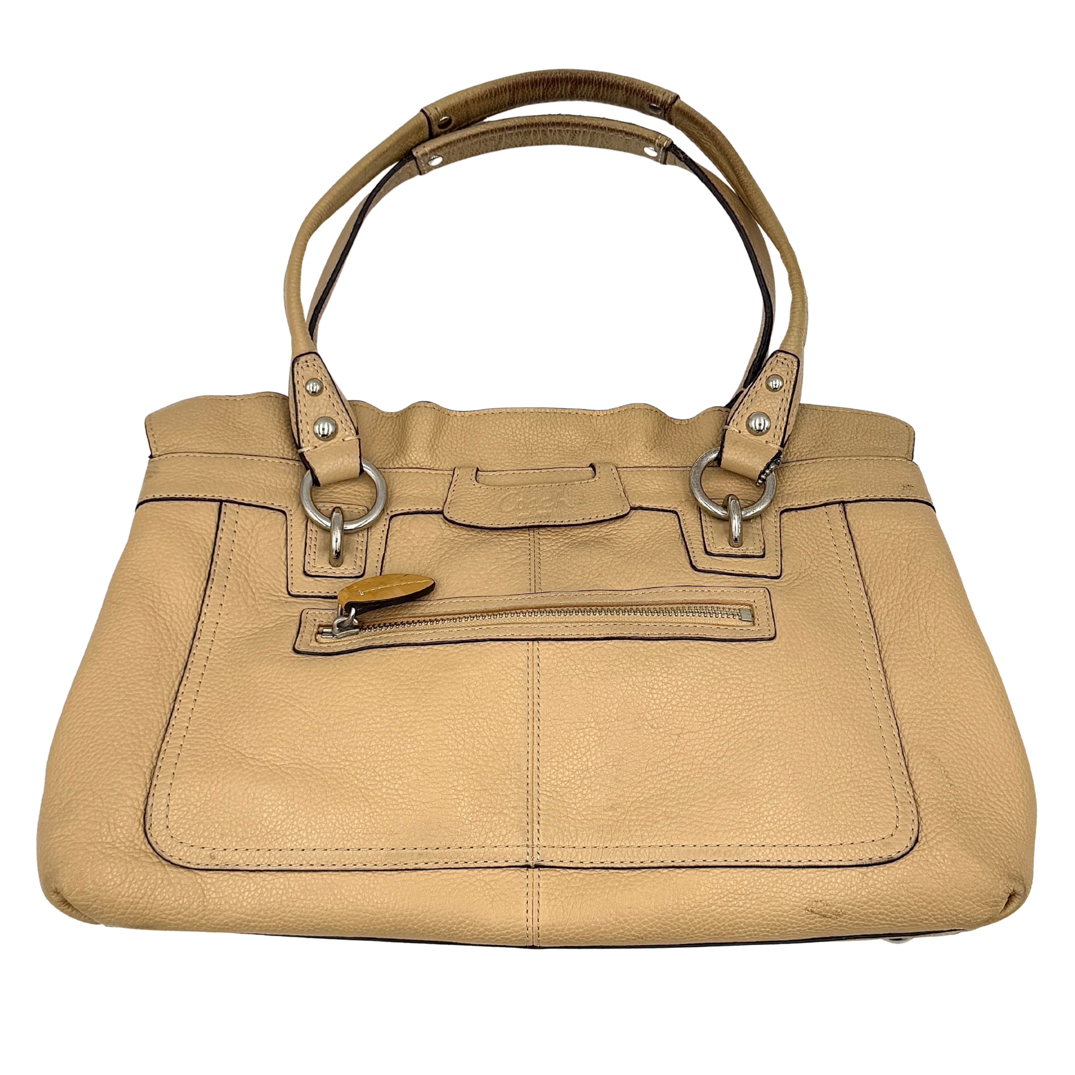 Coach Penelope handbag in cream pebble leather with rolled handles and silver-tone hardware against a white background.