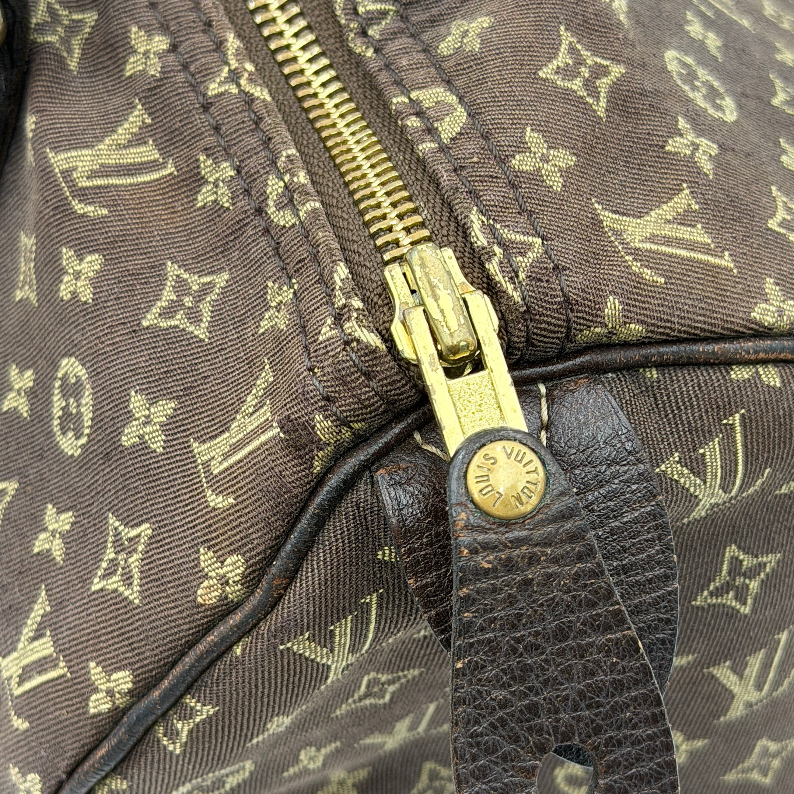 Louis Vuitton Monogram Mini Lin Speedy 30 in brown textile with top handles and monogram motif, shown against a white background.
