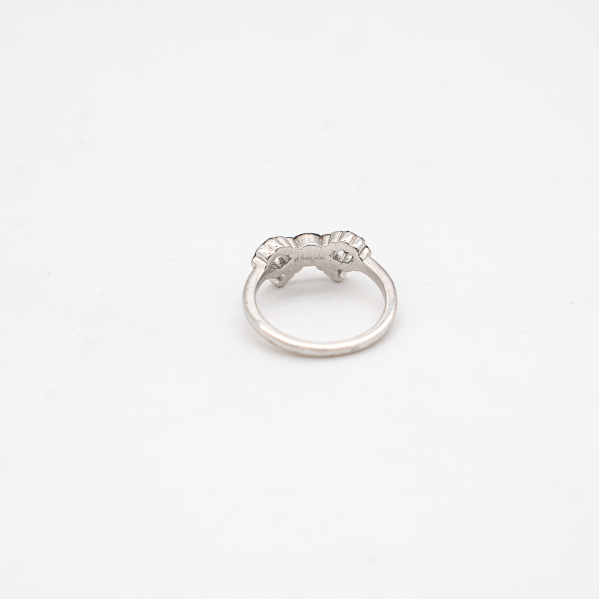 Coach silver ring with a rhinestone-encrusted bow motif, photographed against a white background.