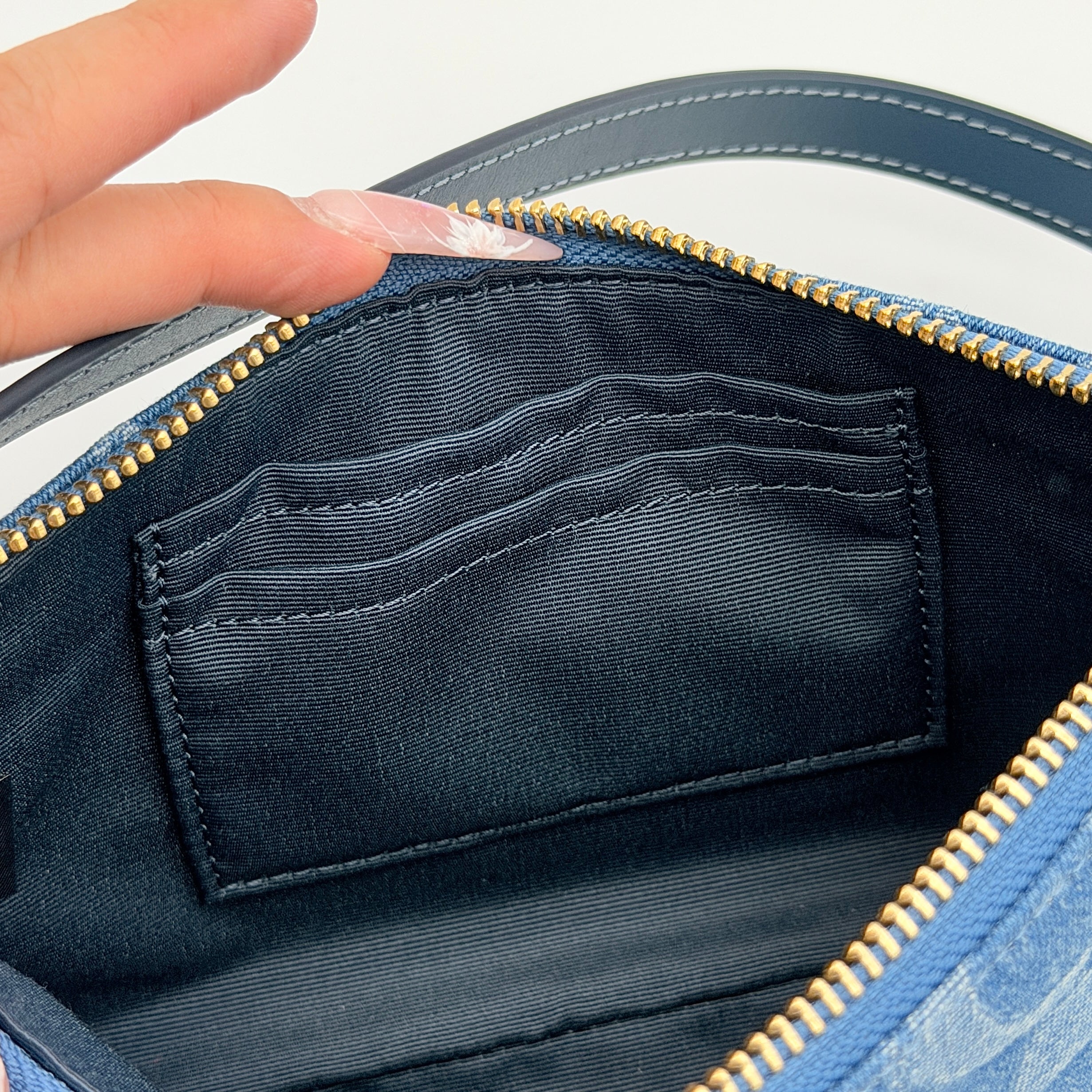 Coach Nolita 19 shoulder bag in blue denim jacquard with monogram print and gold hardware, shown with original packaging.