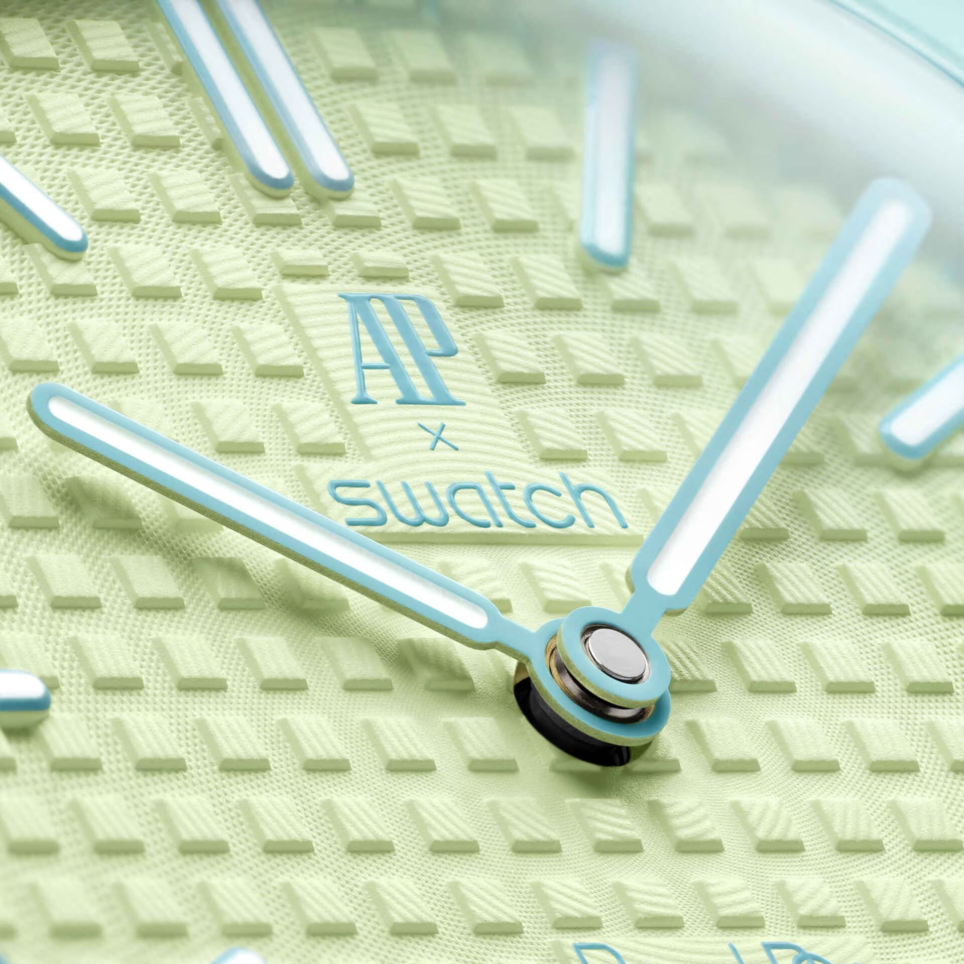 Swatch x Audemars Piguet Royal Pop Blaue Acht pendant watch in pastel green and blue, shown suspended on a matching strap.
