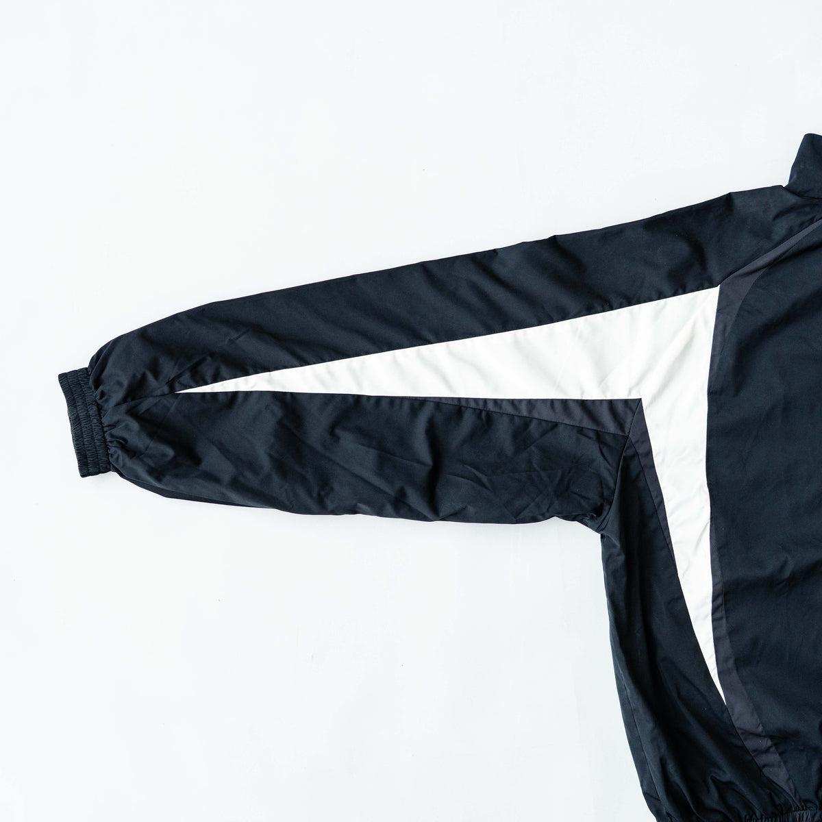 BAPE A Bathing Ape black and white logo track jacket with bold panel detailing, shown laid flat.