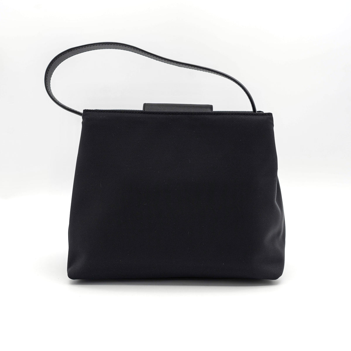 Coach Mercer tote bag in black nylon with leather handle and trim, presented against a white background.