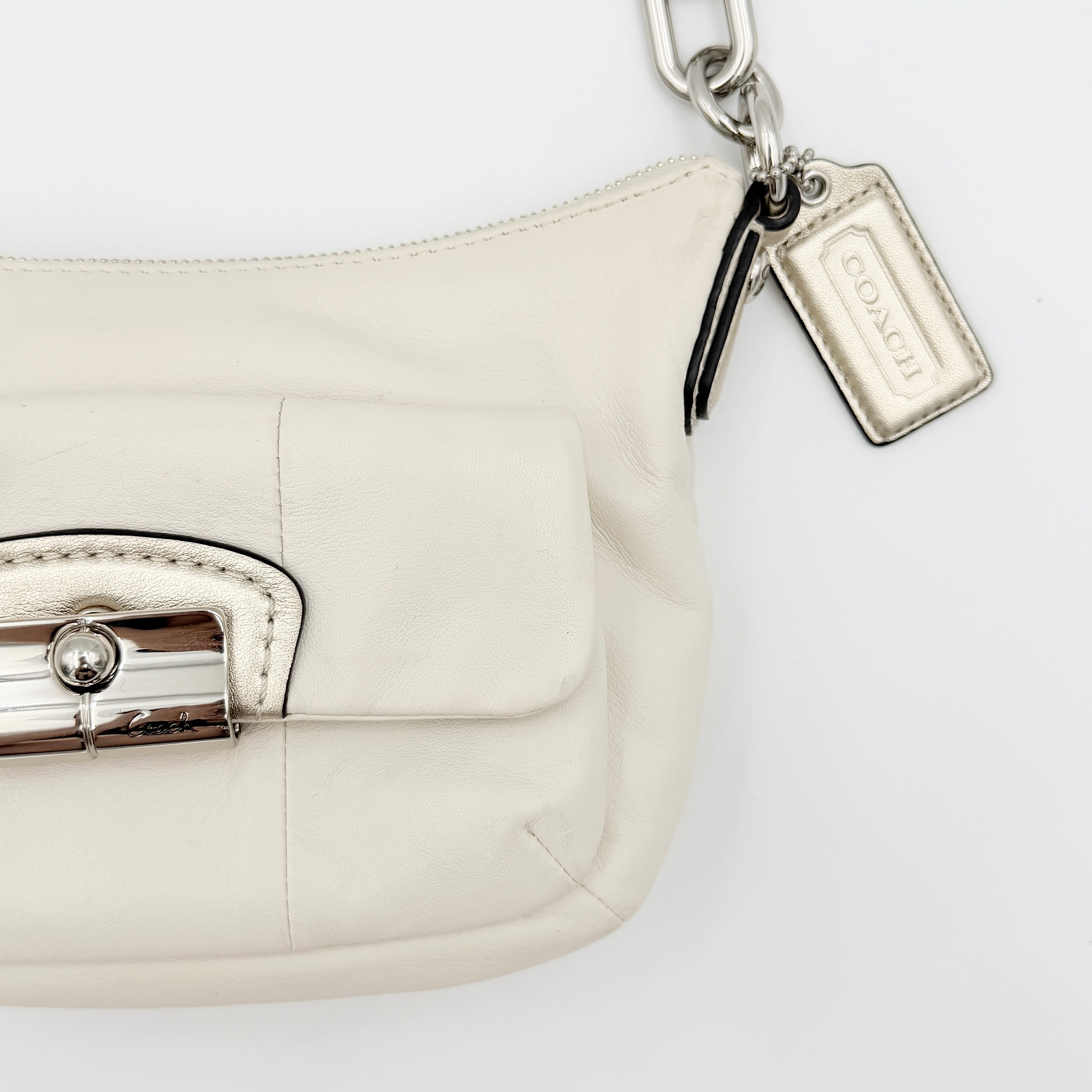 Coach Kristin Hobo Shoulder Bag in ivory leather with silver-tone hardware and a structured short strap.