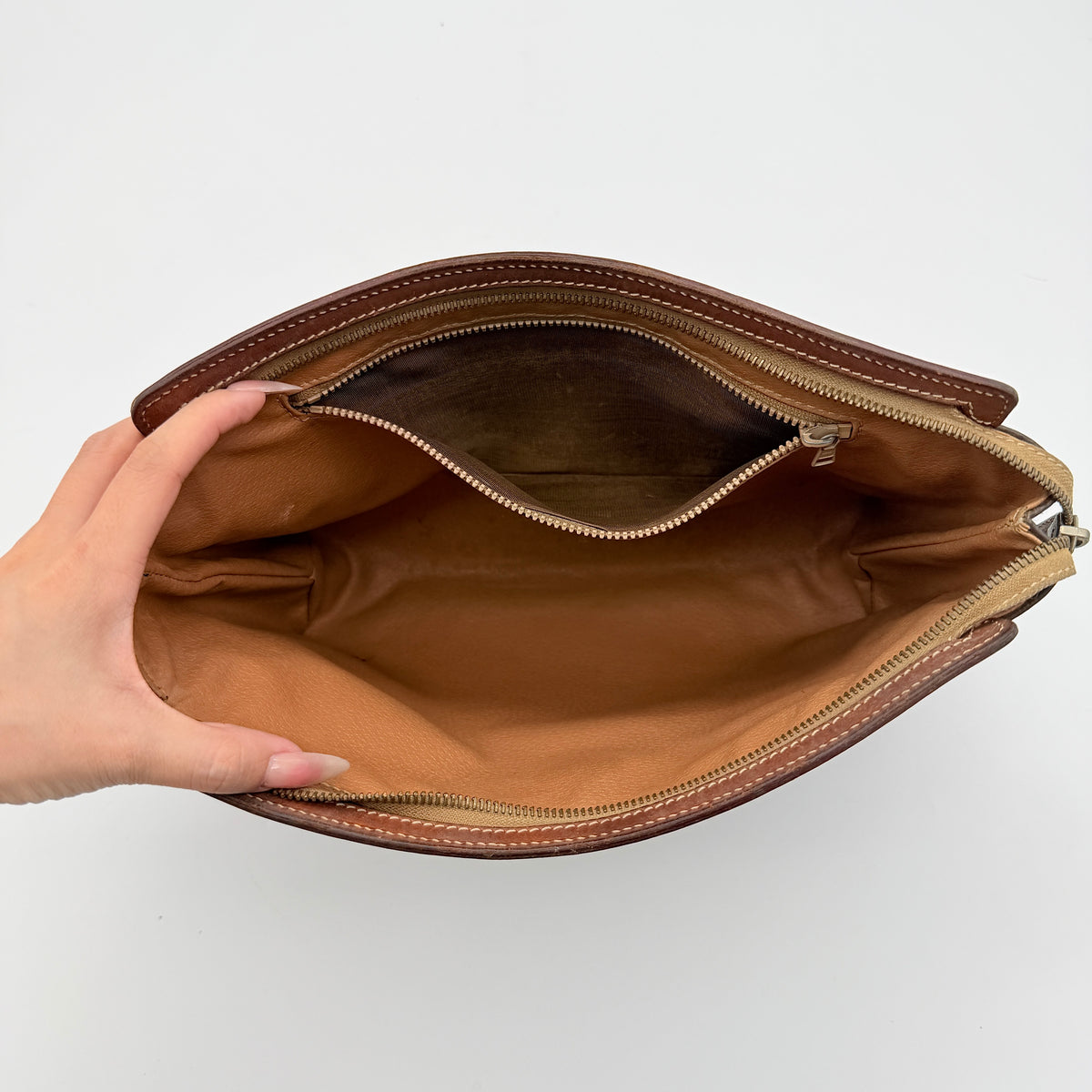 Celine Triomphe Macadam Clutch Bag in brown coated canvas with leather trim, photographed on a white background.