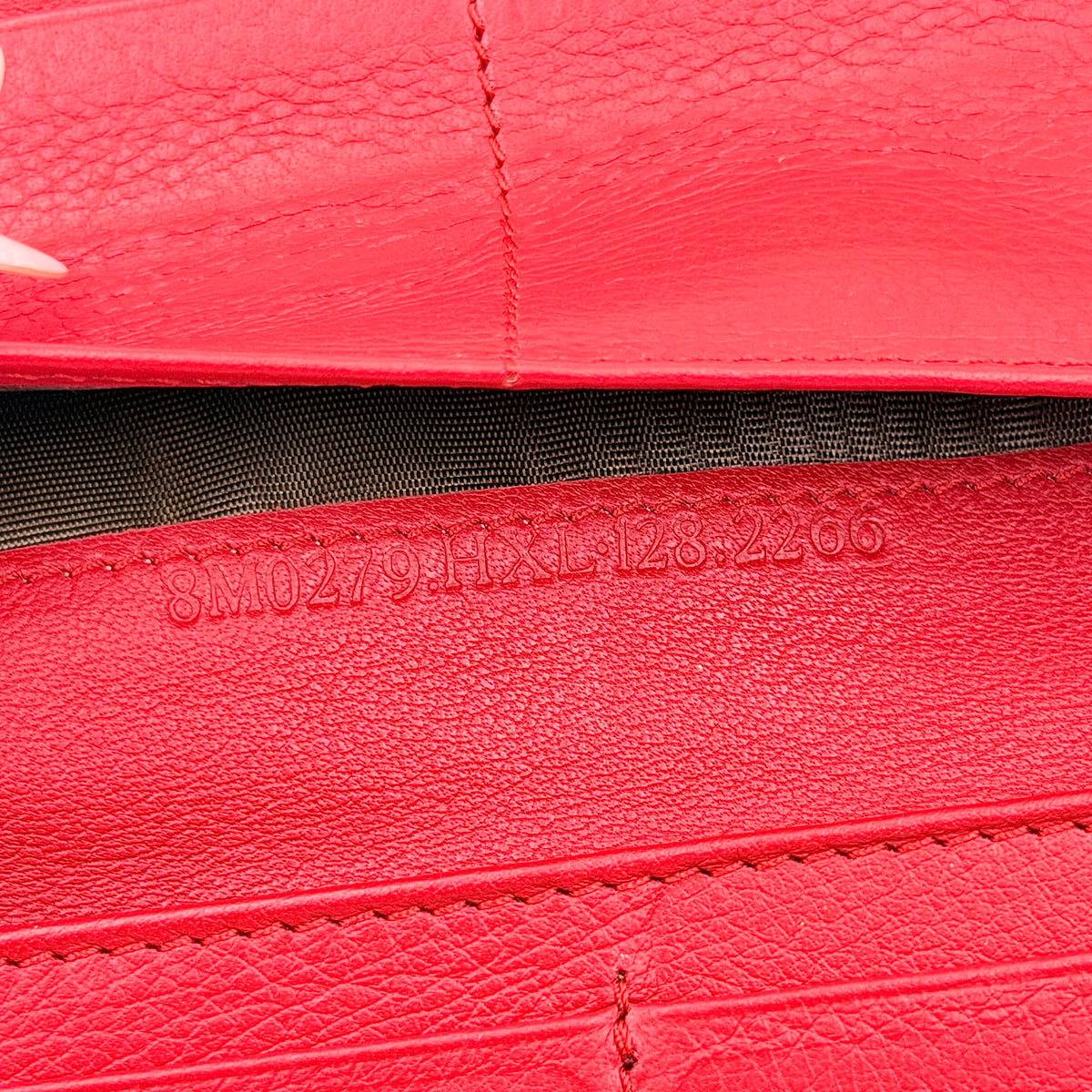 Fendi FF Logo Buckle Flap Continental Wallet in red leather with gold hardware, displayed closed on a white background.