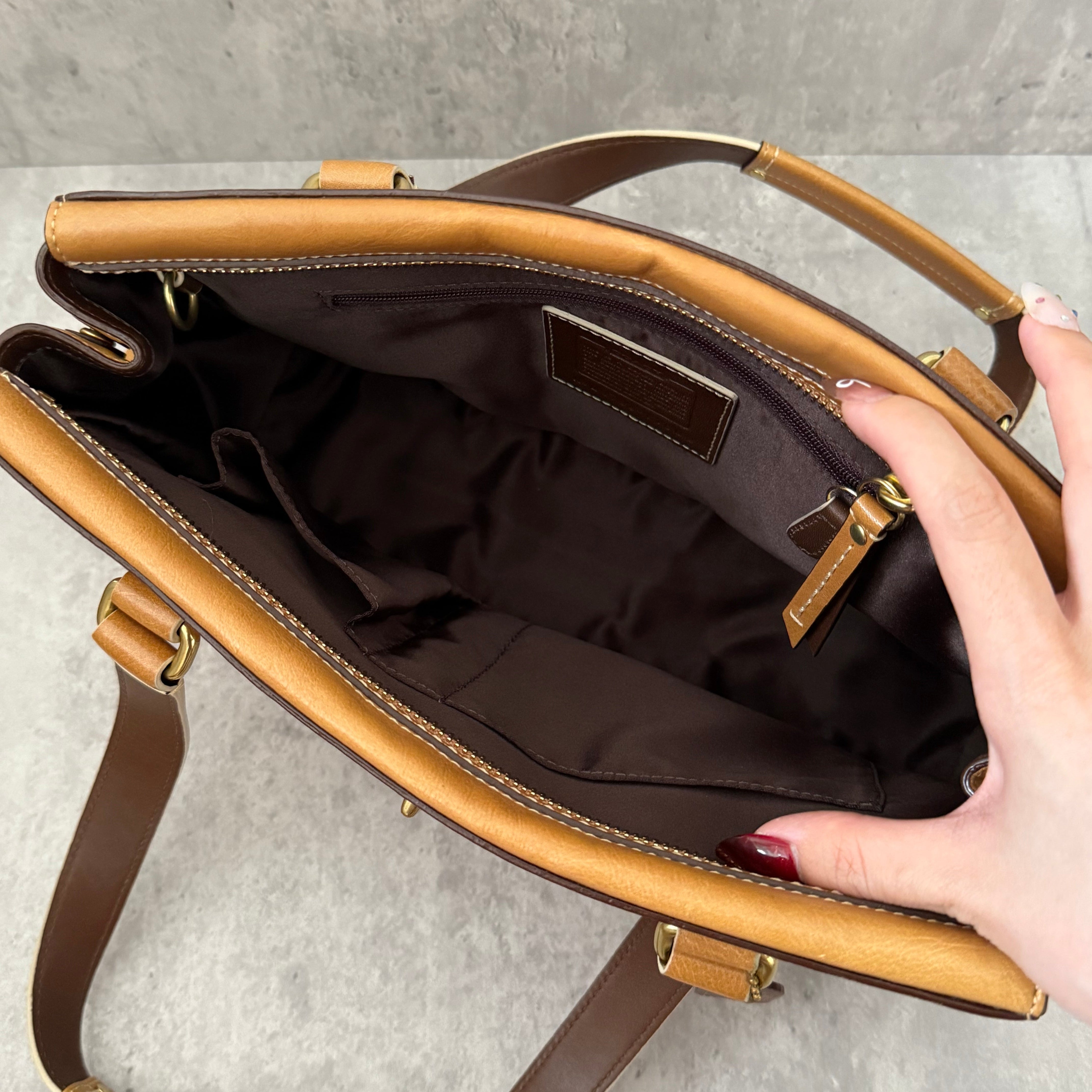 Coach Hampton Vintage Brown Beige Tan Handbag, crafted in leather with embossed signature panel, patent leather stripes, gold-tone hardware, and dual shoulder straps.