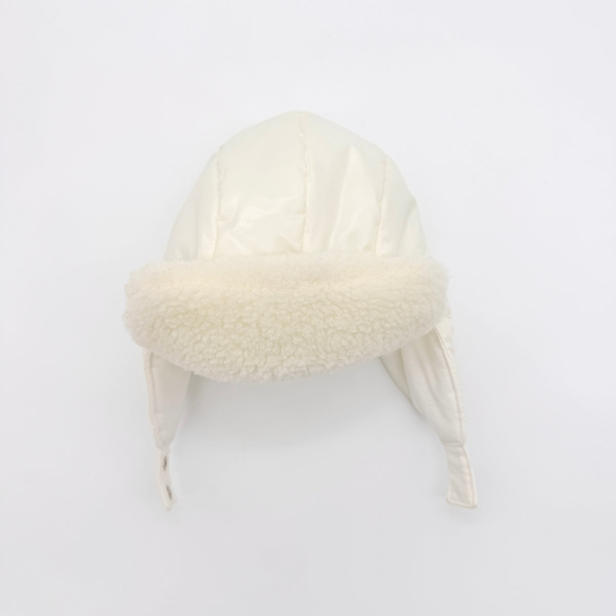 Moncler ivory quilted trapper hat with plush faux fur trim and signature logo patch displayed on white background.