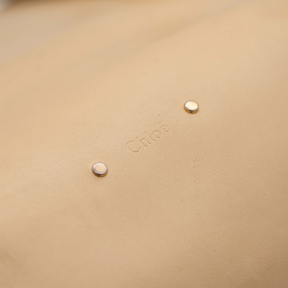 Chloé C Zipped Tote Bag in beige leather with gold hardware, shown with structured dual straps and front logo detail.