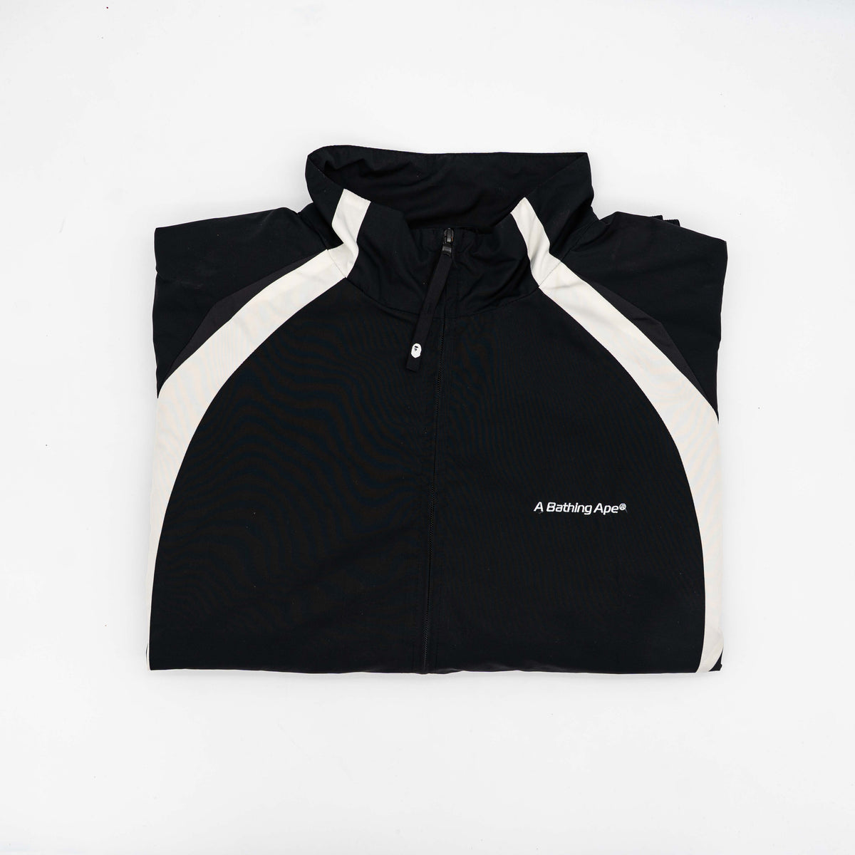 BAPE A Bathing Ape black and white logo track jacket with bold panel detailing, shown laid flat.