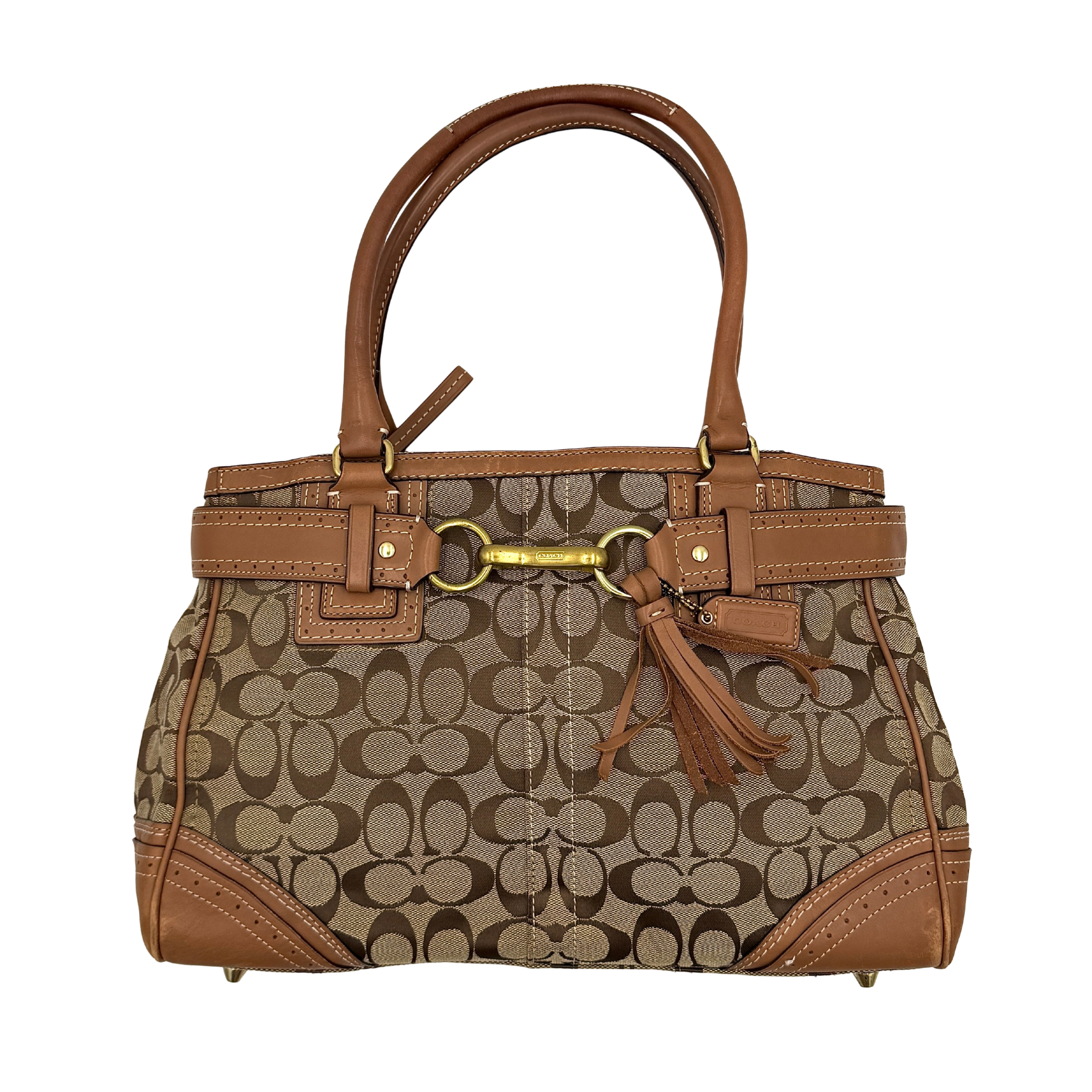 Coach Signature Hampton Carryall Shoulder Bag in beige and tan canvas with caramel leather trim, gold hardware, and tassel detail, shown standing upright.