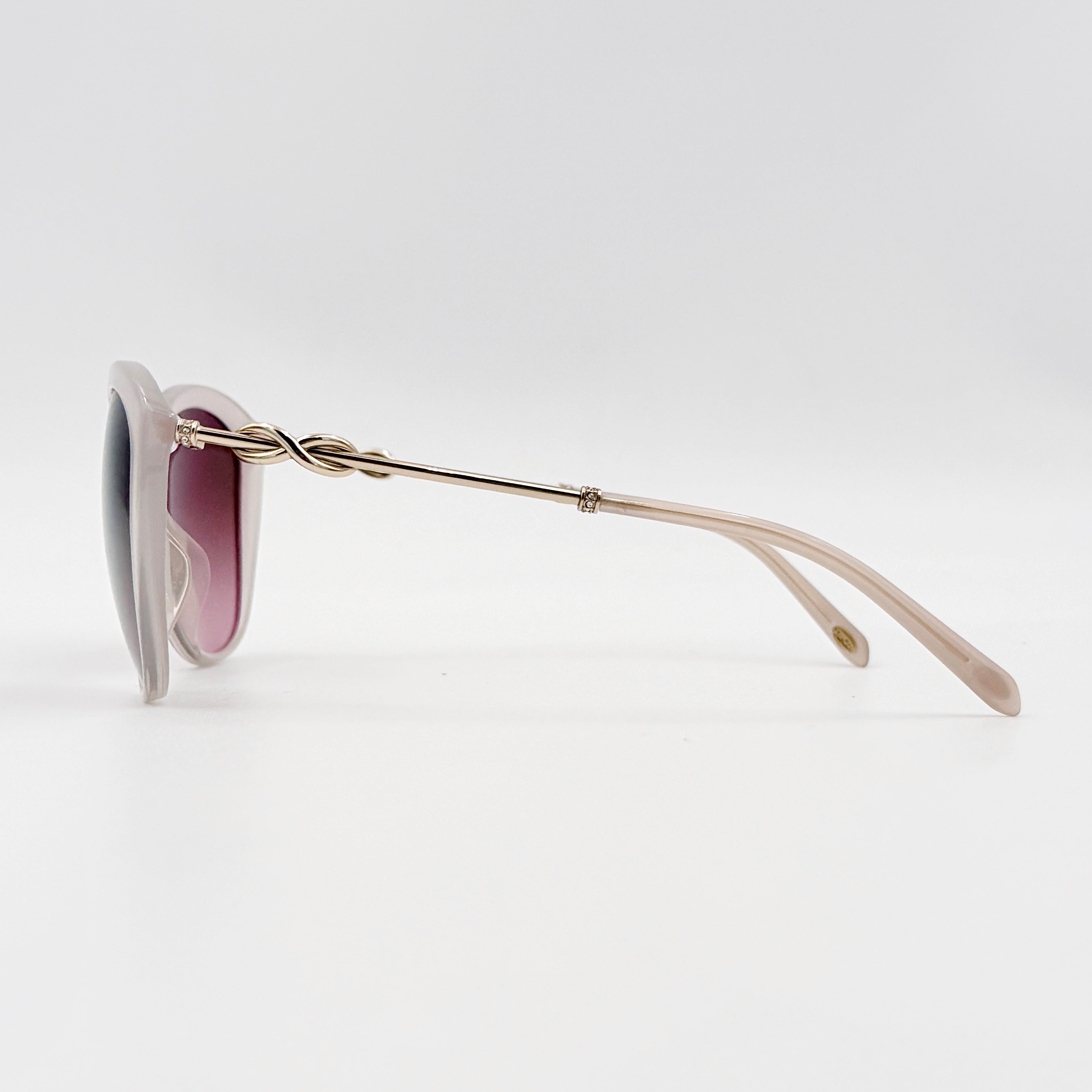 Tiffany & Co. TF4144 sunglasses in pink with gold-tone knot detail arms, shown with signature blue case.