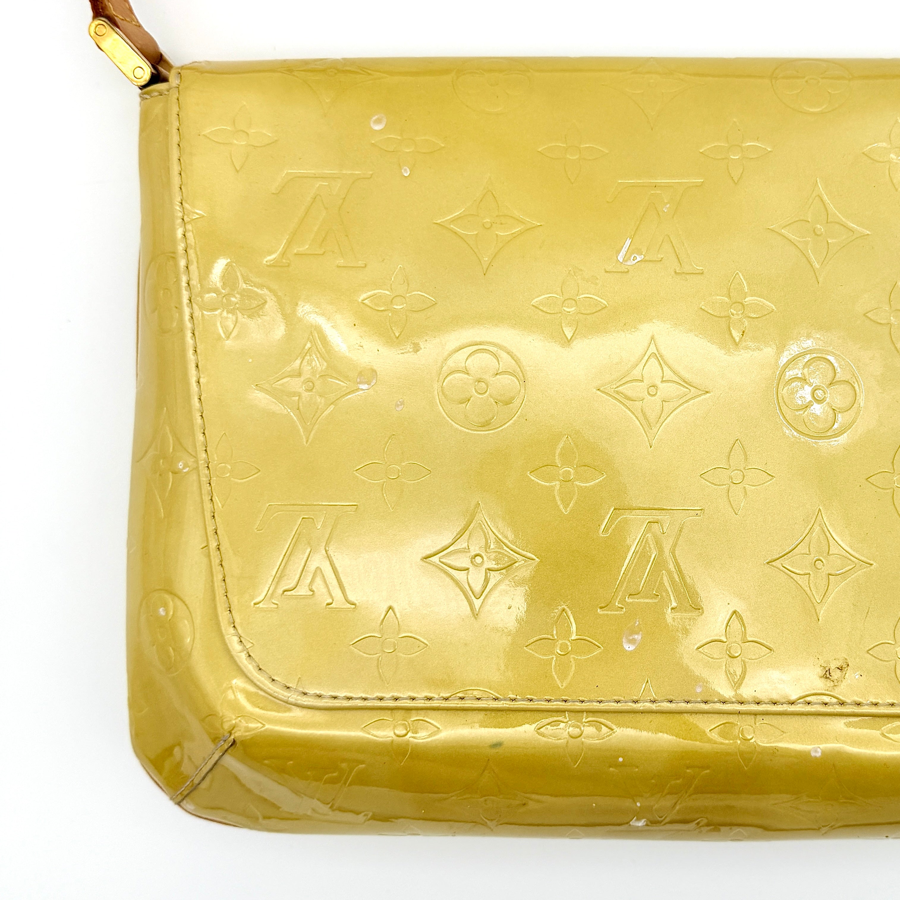 Louis Vuitton Thompson Street bag in yellow Monogram Vernis leather with adjustable shoulder strap and gold-tone hardware.