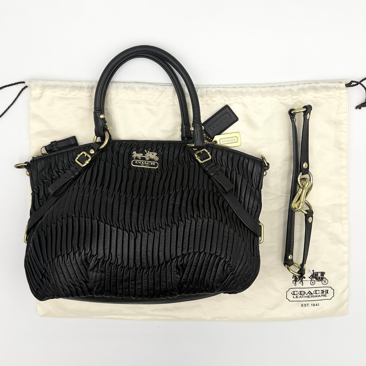 Coach Sophia Madison Pleated Shoulder Bag in black leather with gold hardware, displayed with detachable strap and dust bag.