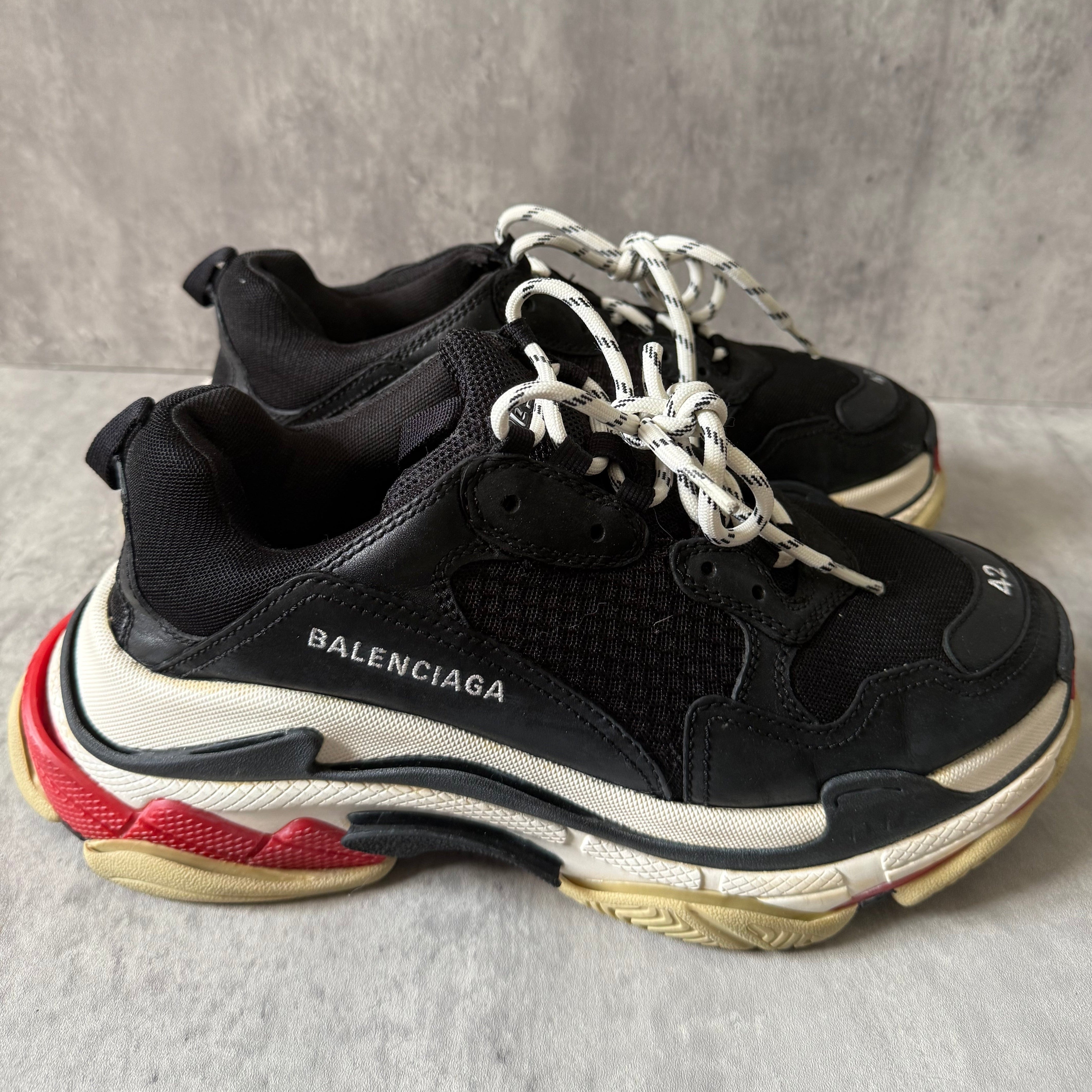Balenciaga Triple S Black White Red sneakers, featuring layered mesh and leather upper, distressed sole, and oversized silhouette with embroidered size 42.