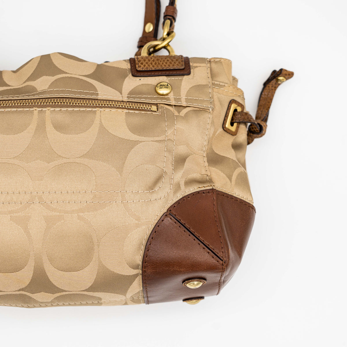 Coach Signature Peyton Shoulder Bag in brown sateen and leather with gold-tone hardware and turnlock pocket, photographed on a white background.