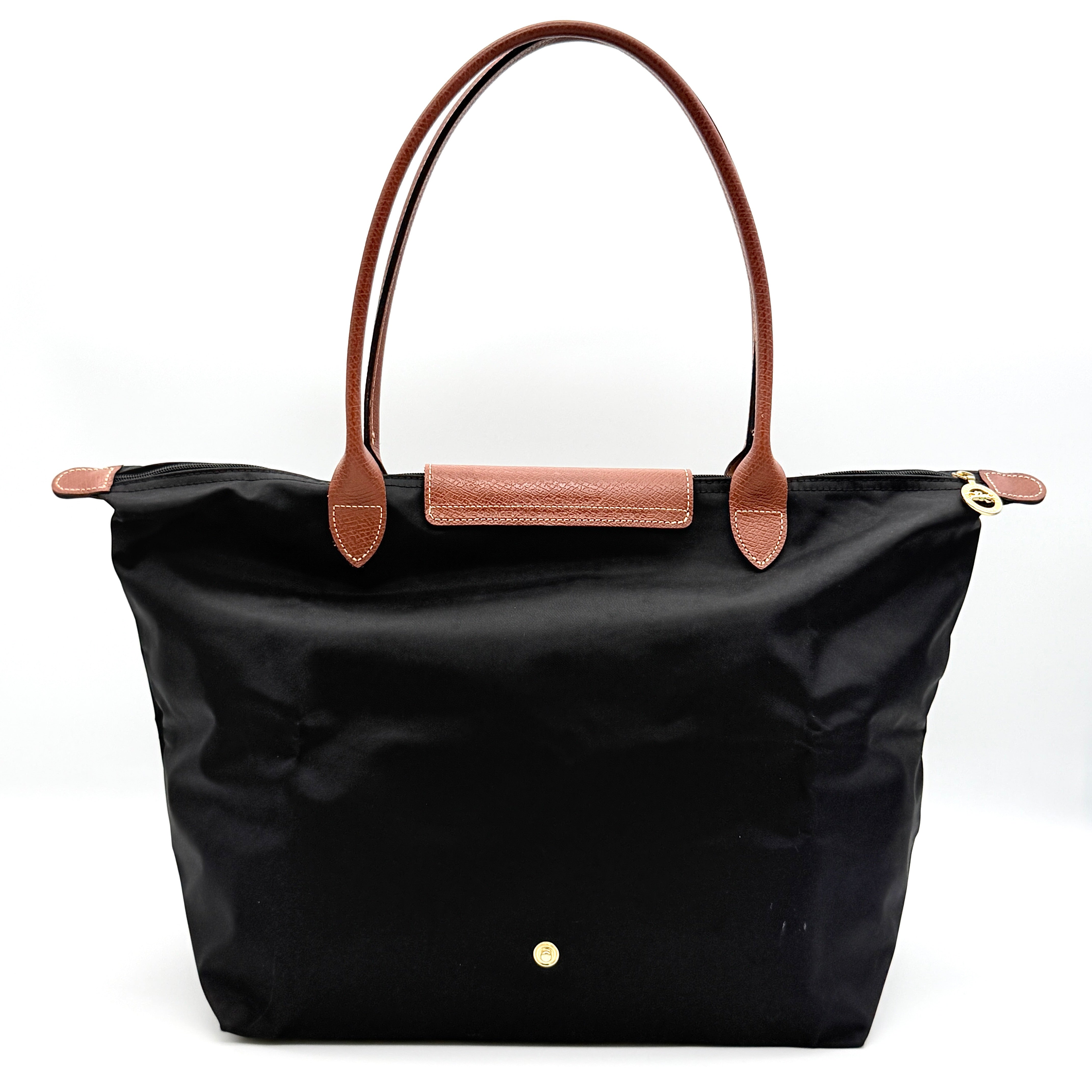 Longchamp Le Pliage Original Tote Bag in black with brown leather handles and flap, photographed against a white background.