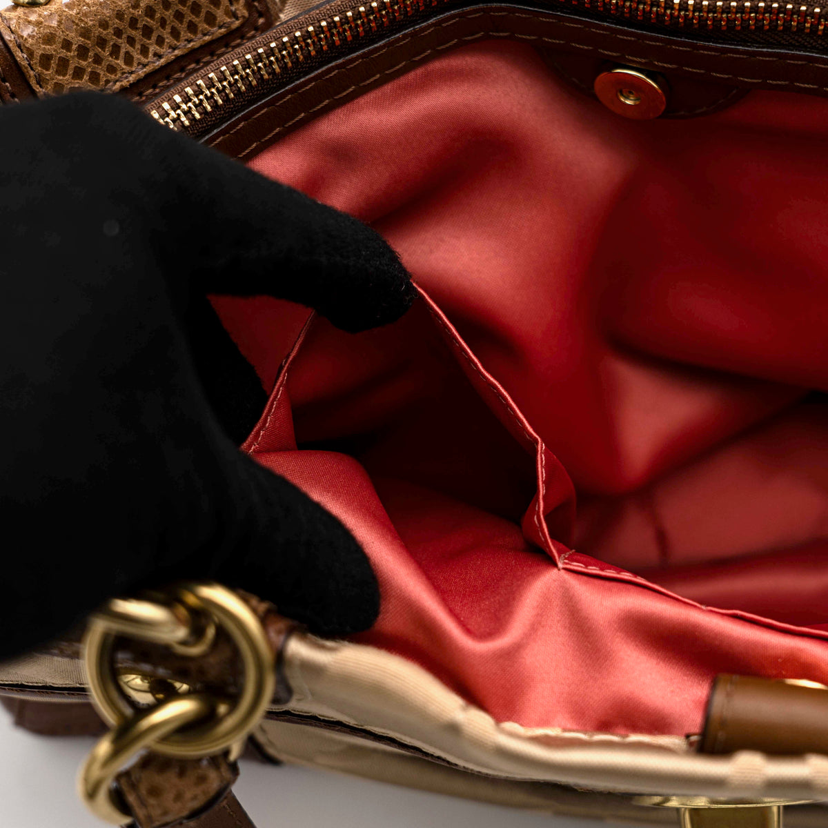 Coach Signature Peyton Shoulder Bag in brown sateen and leather with gold-tone hardware and turnlock pocket, photographed on a white background.
