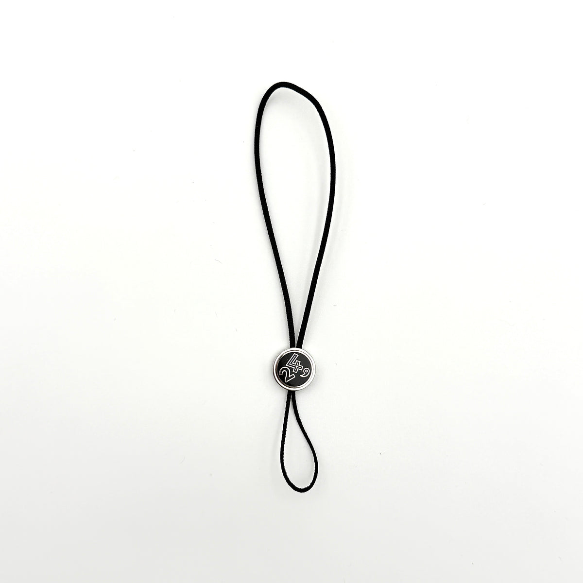 Hermès black cord cell phone charm strap with round silver-tone graphic accent, shown against a white background.
