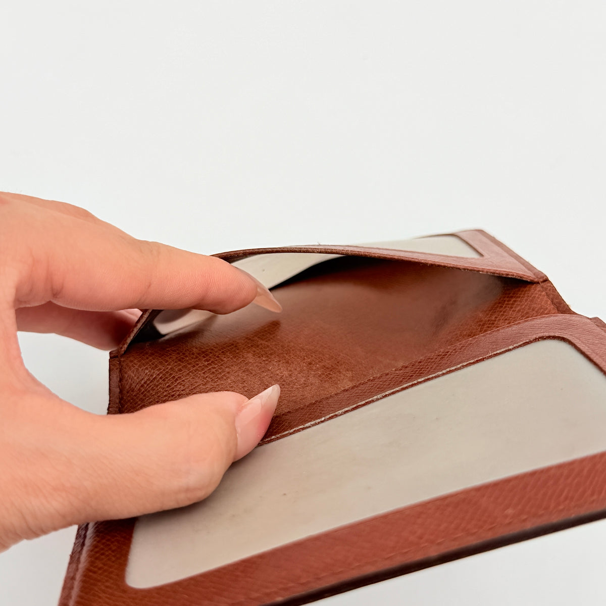 Louis Vuitton Monogram ID Card Holder in brown coated canvas with signature pattern and brown leather interior.