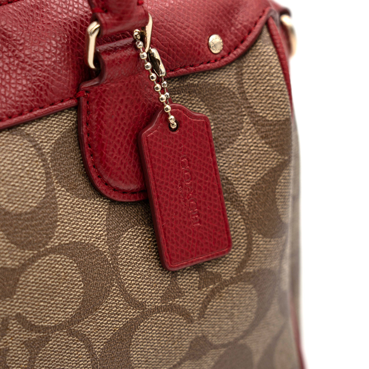 Coach Mini Bennett Boston bag in signature beige canvas with red leather trim, shown with detachable crossbody strap.