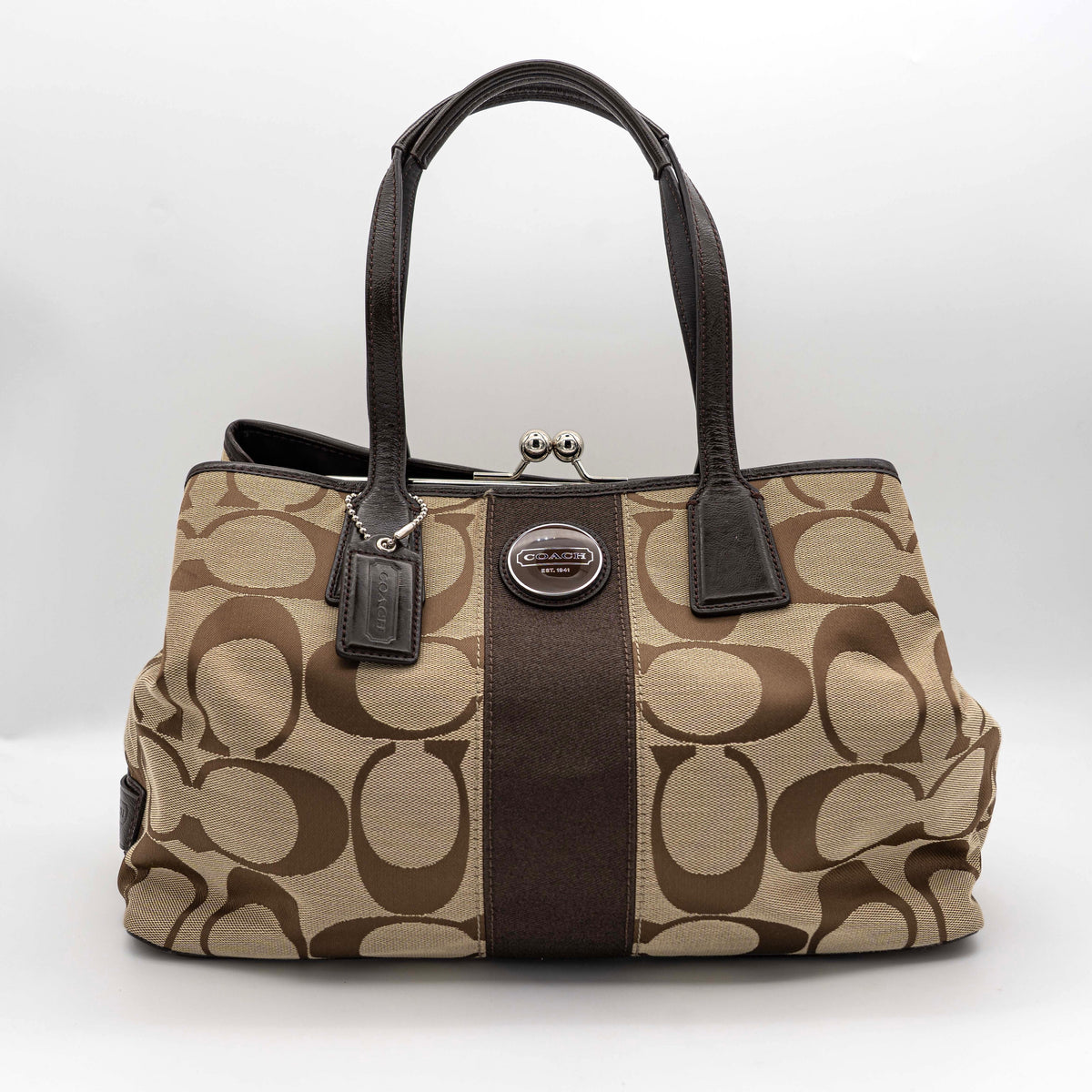 Coach Signature Stripe Frame Kisslock Shoulder Bag in beige and brown canvas with leather trim and signature monogram pattern.
